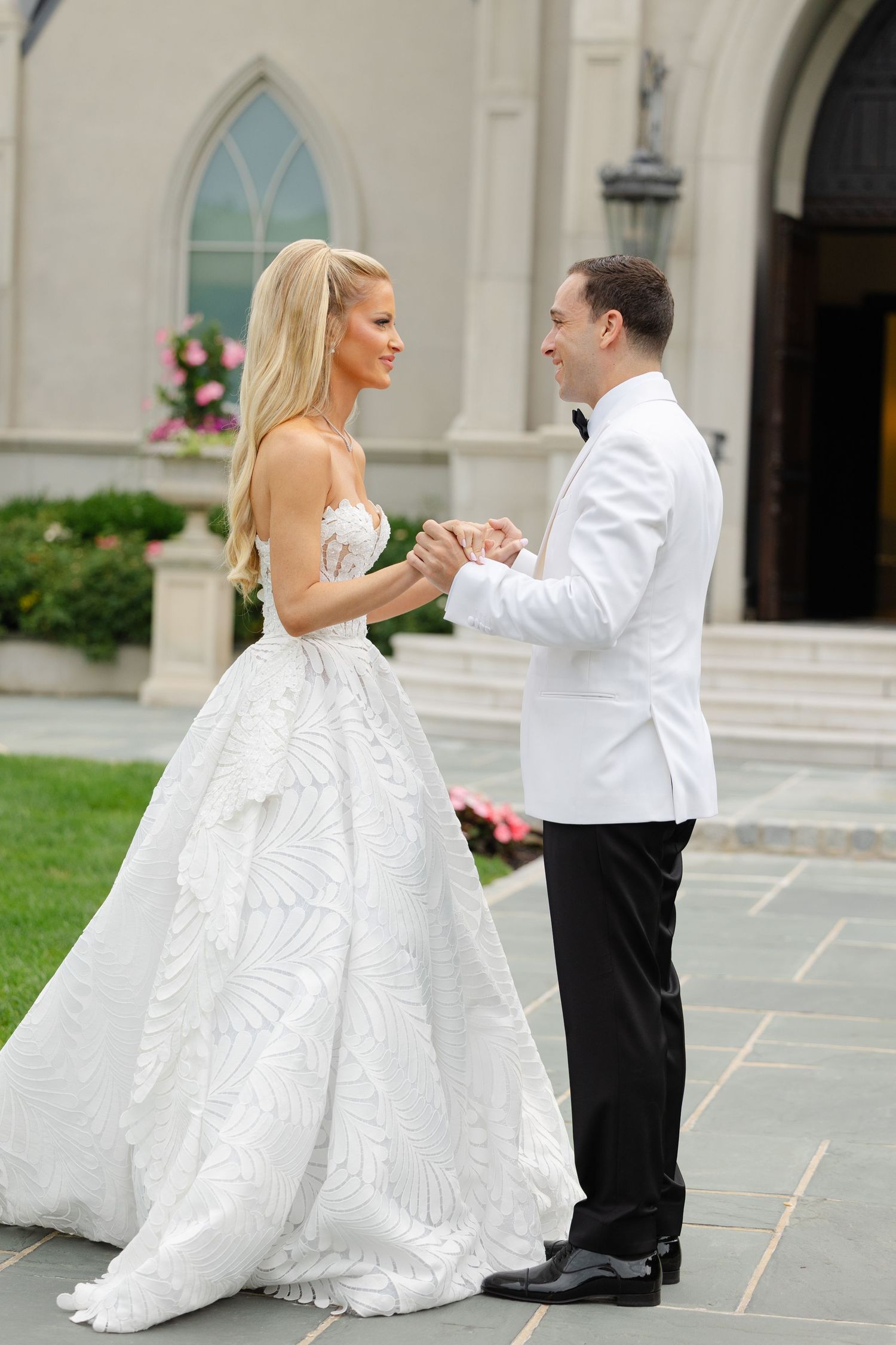 A bride and groom share a romantic dance moment together outside a church building in a series of candid shots.