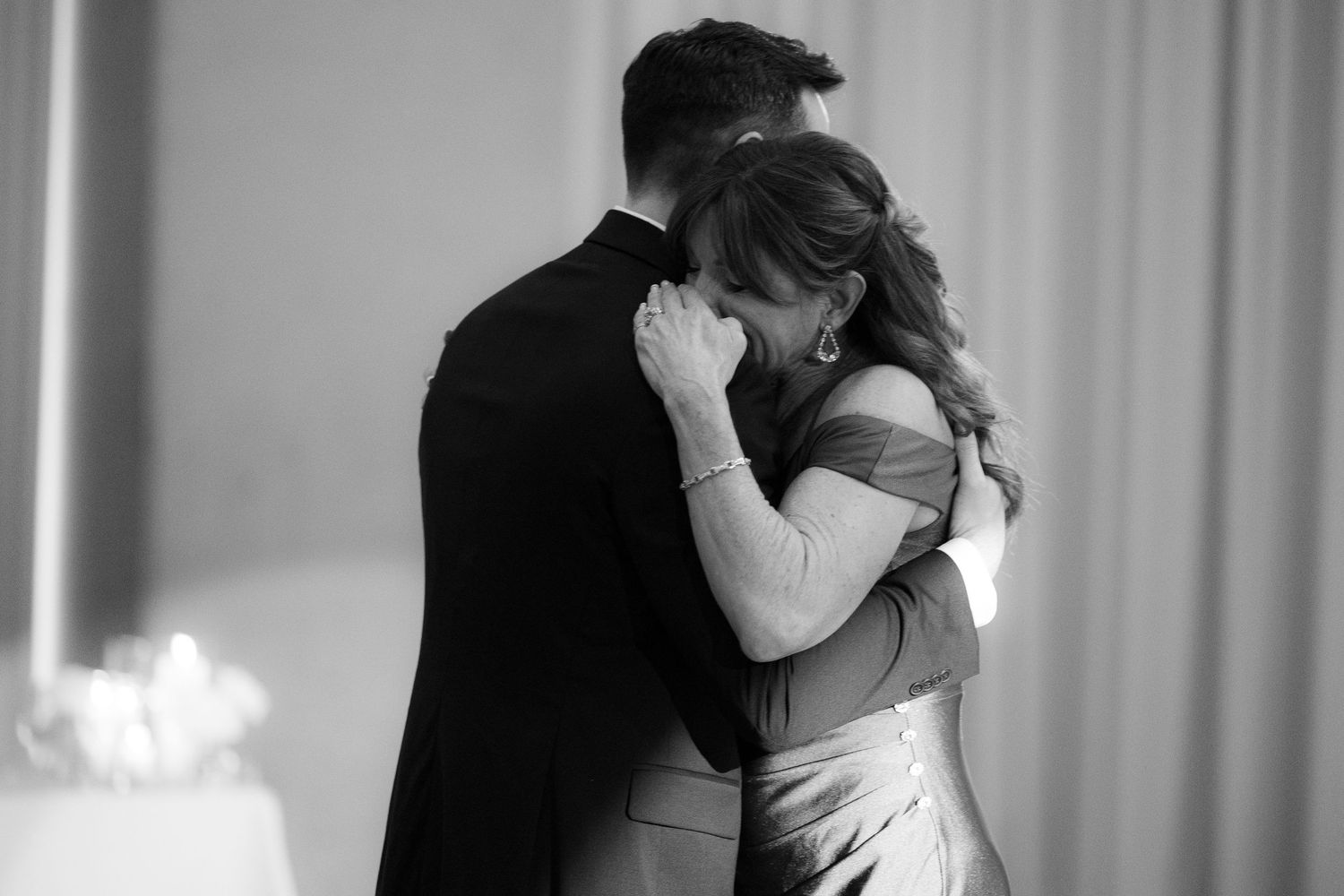 A romantic black and white photo collage showing tender moments between a couple embracing and kissing.