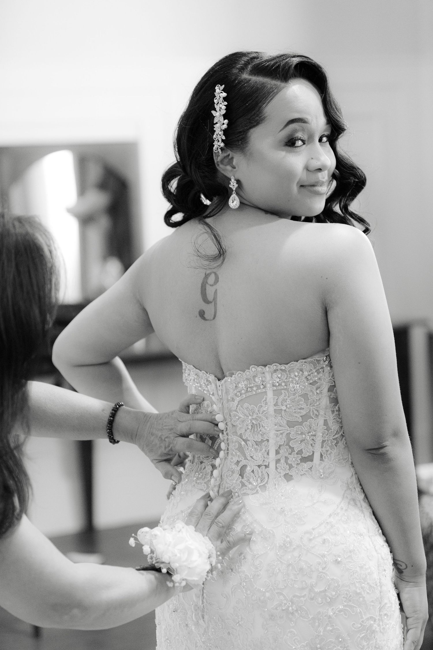 A bride in a white lace strapless wedding dress is shown in a series of artistic black and white photos.