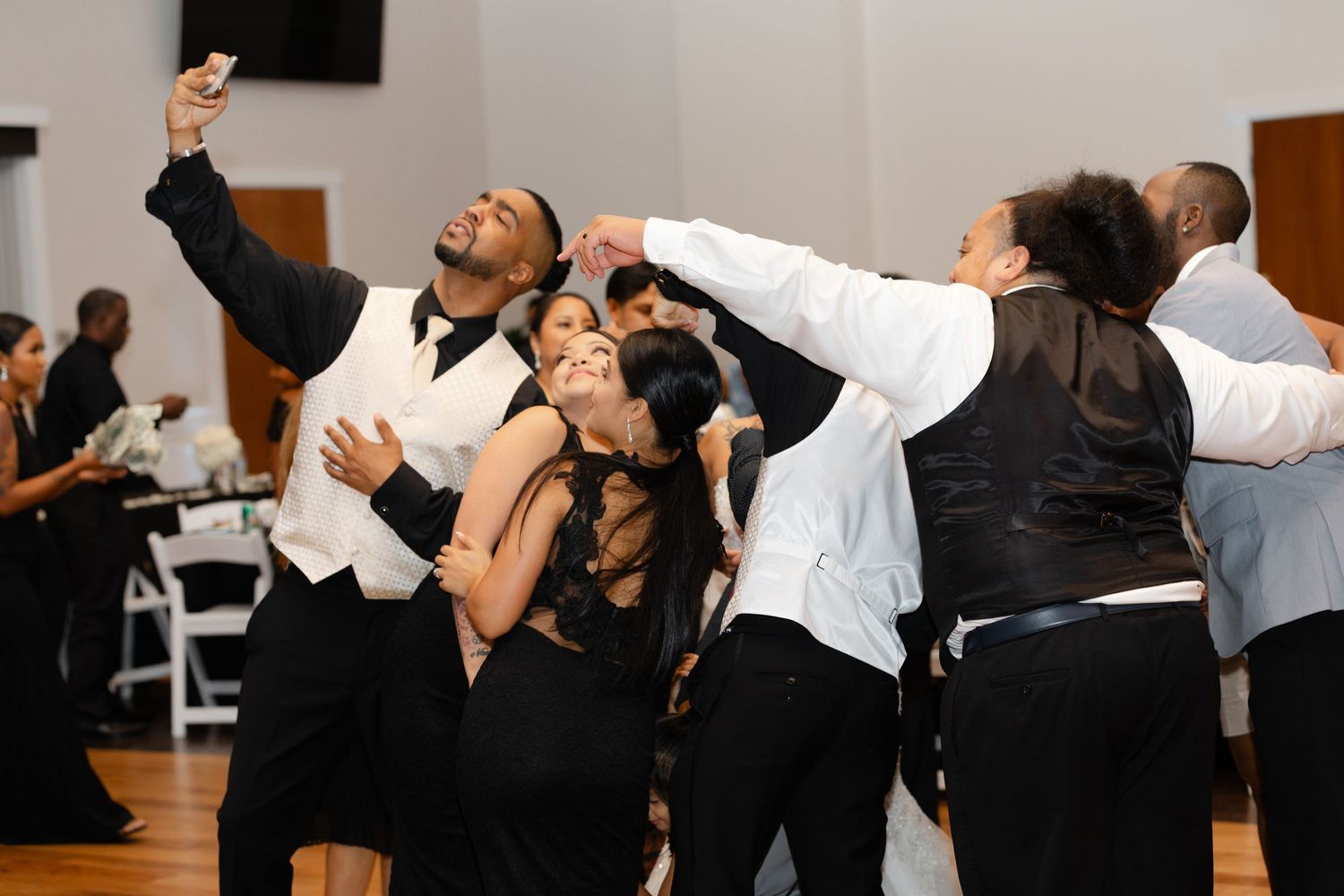 People dancing and enjoying themselves at a social dance event in a bright indoor space.
