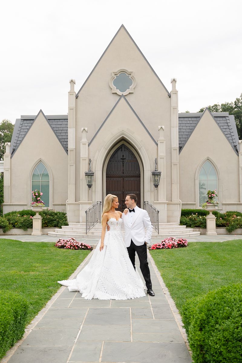 A series of photos showing a couple walking along a path in front of a beautiful stone Gothic church with arched windows.