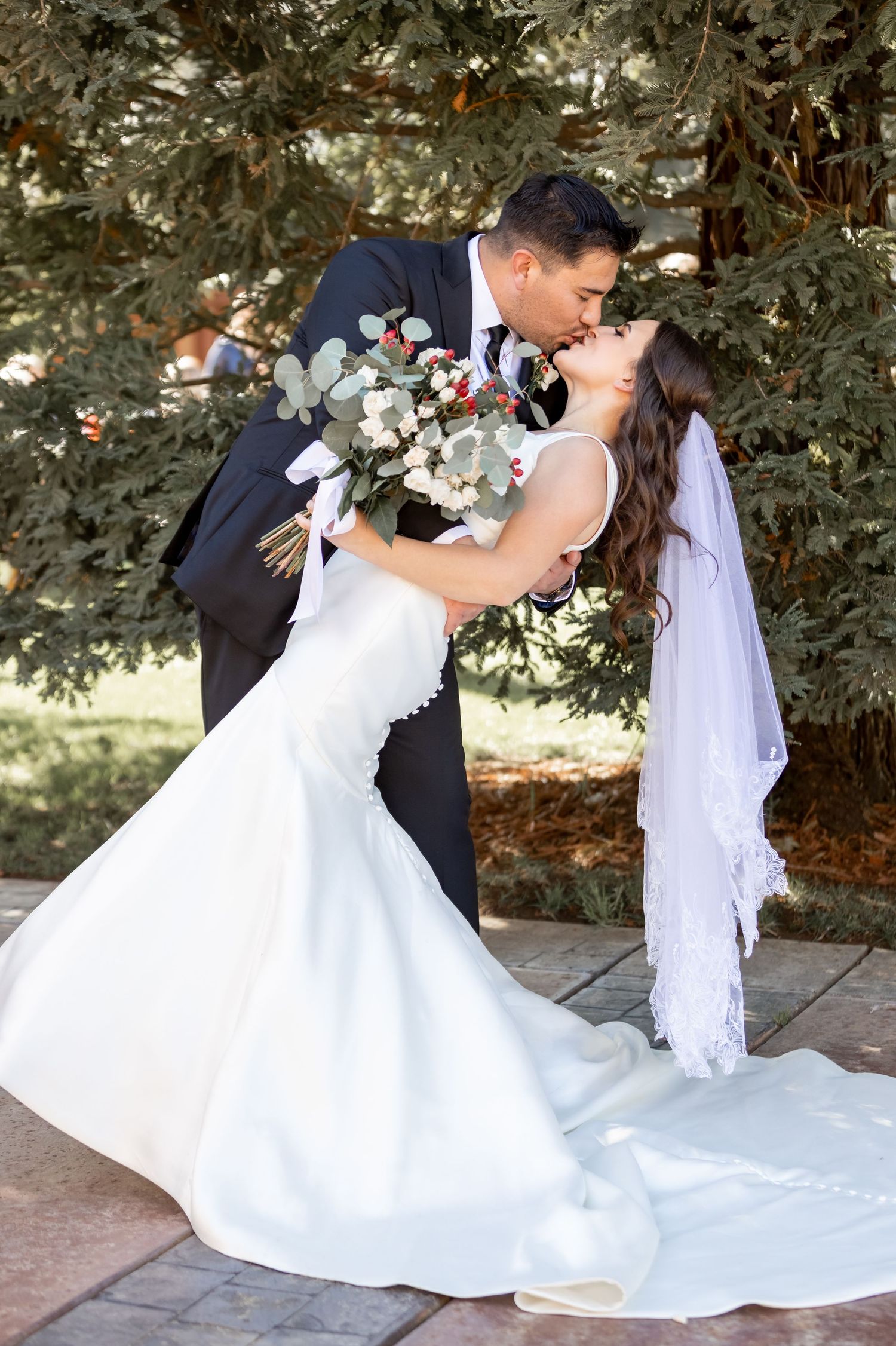 Romantic wedding photo sequence showing couple in traditional poses under trees.