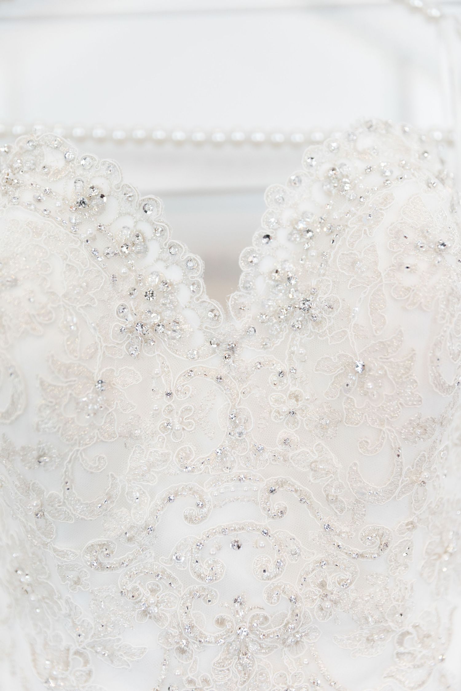 Close-up view of white soap bubbles or foam with delicate swirling patterns and tiny air pockets.