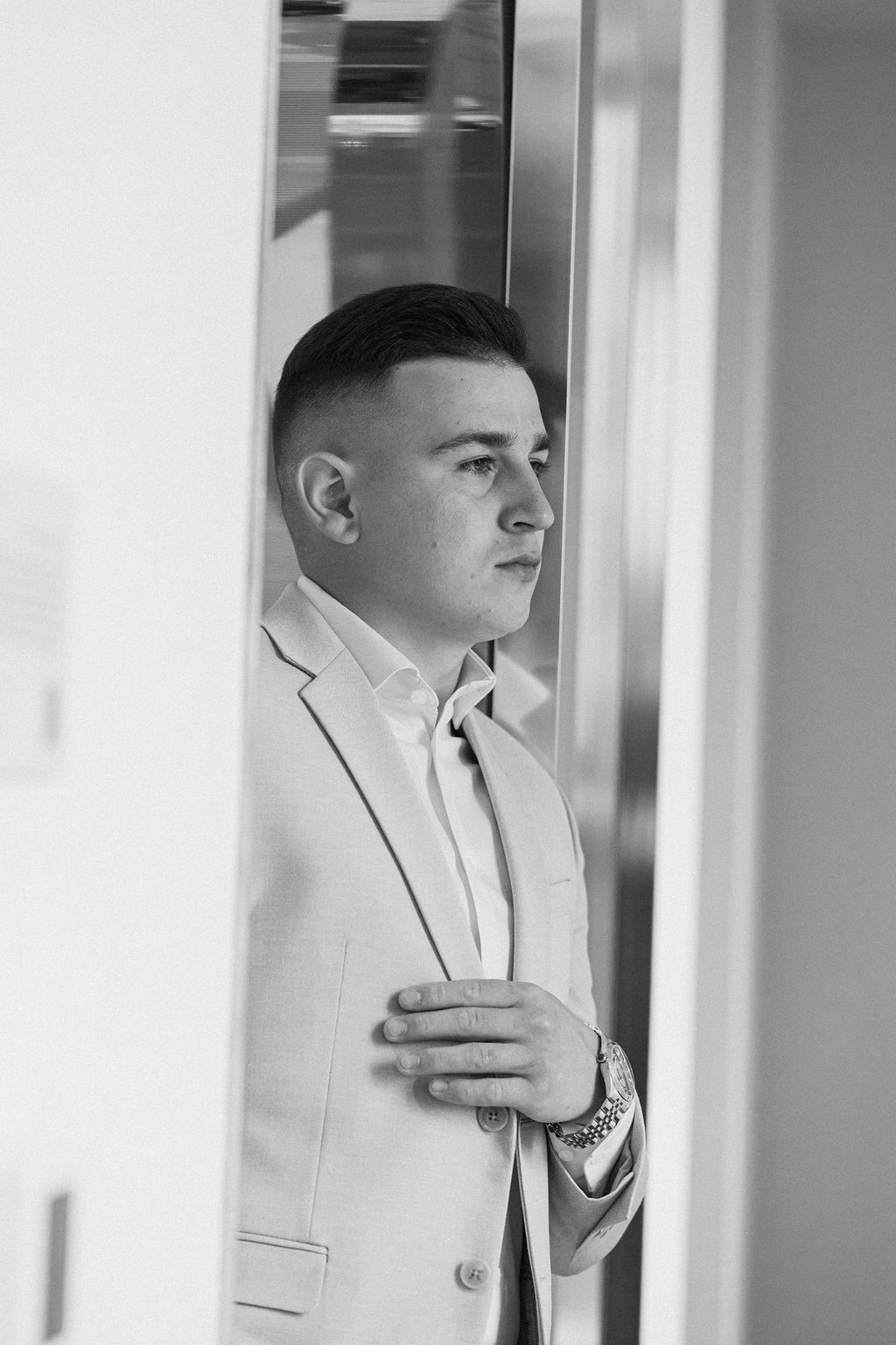 A series of reflective portraits showing a person in a light-colored suit looking pensively to the side.