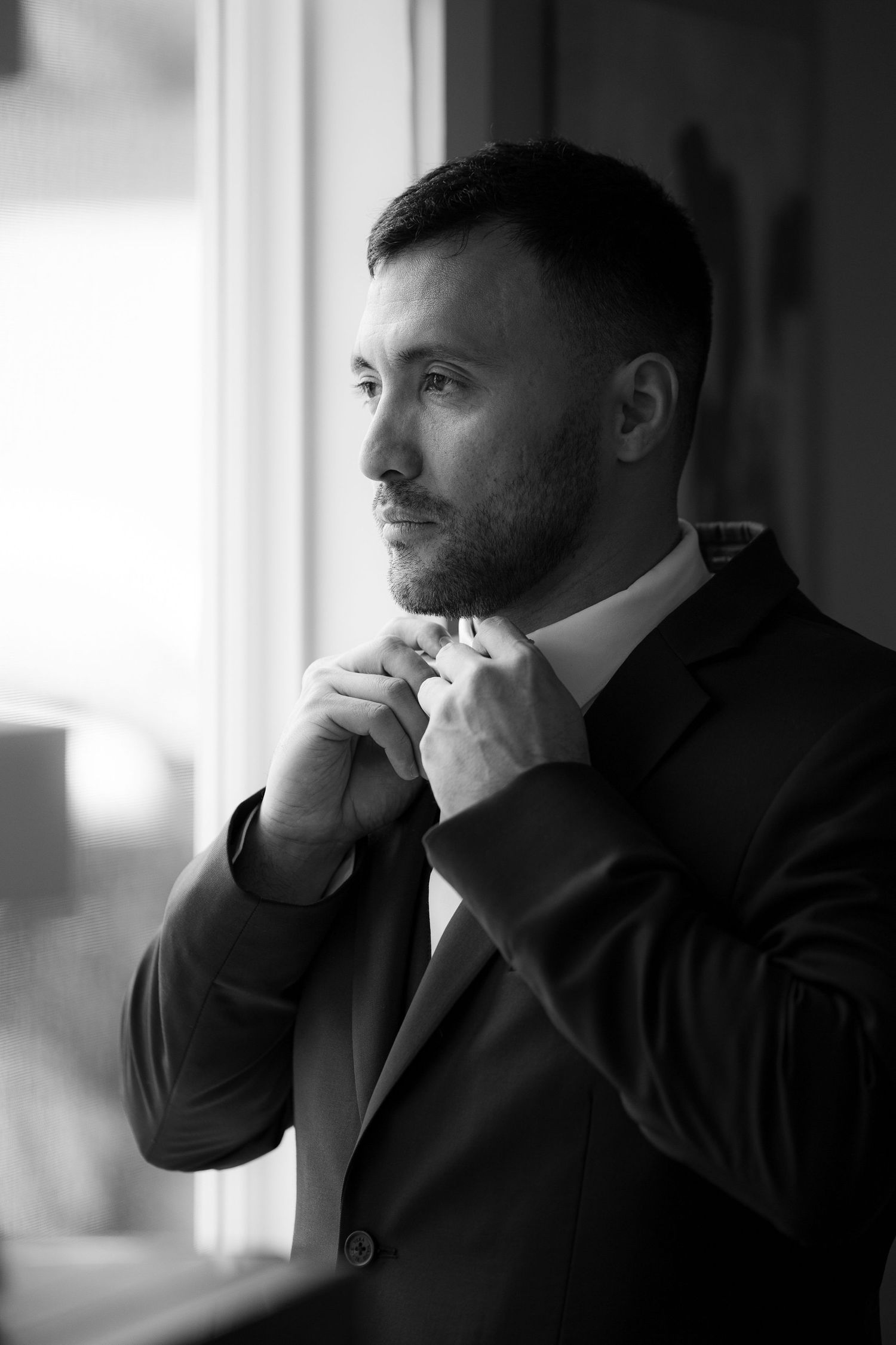 Black and white photo series showing a contemplative person in business attire looking off to the side.