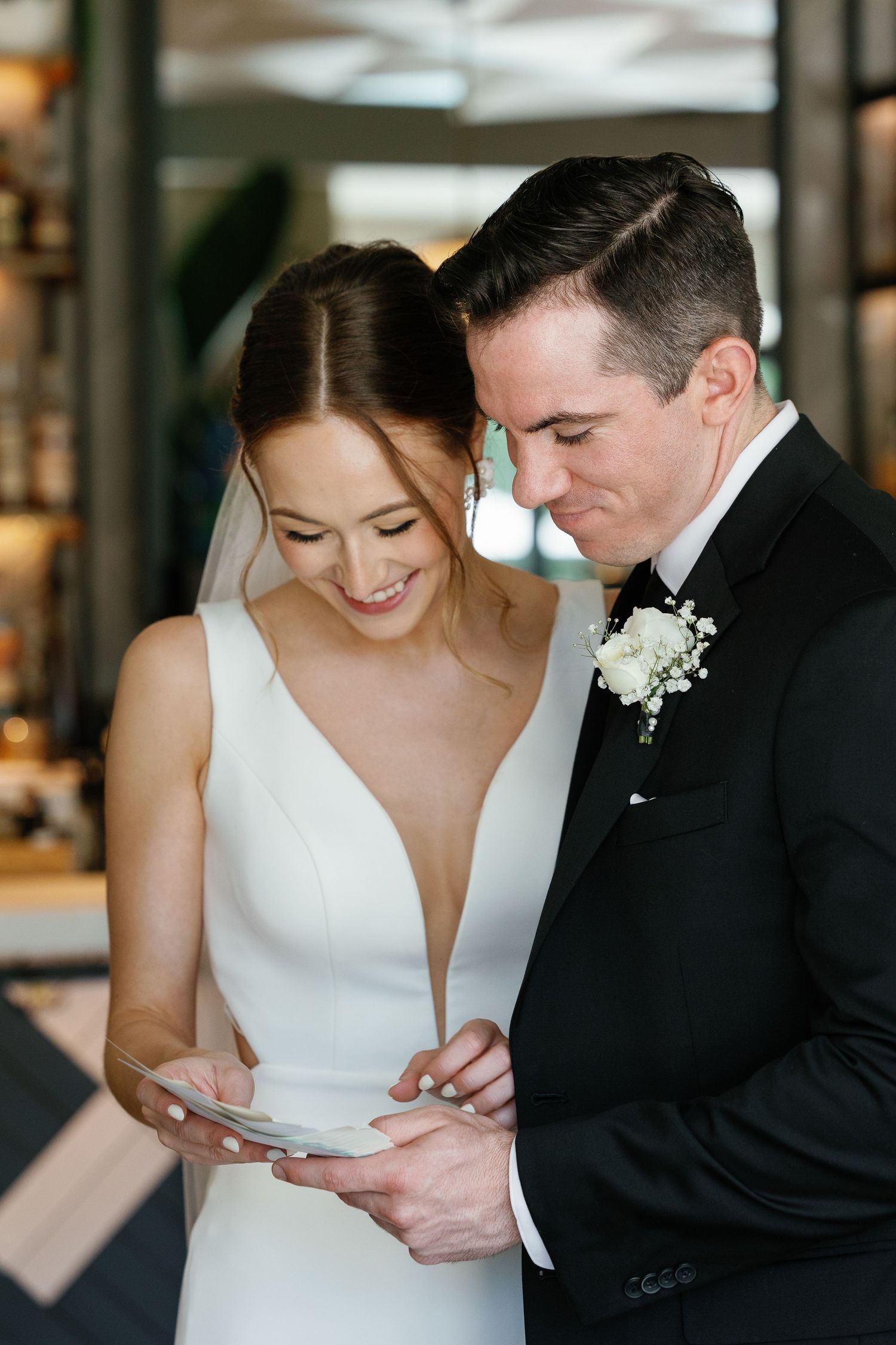 A tender moment between newlyweds as they share a close embrace in formal wedding attire.