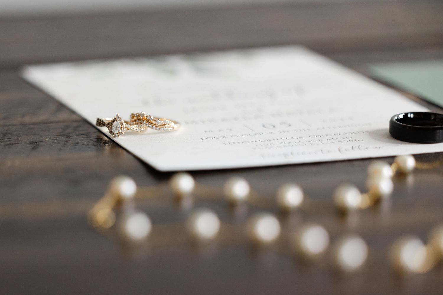 Wedding detail shot of handwritten vows with string lights in soft focus.