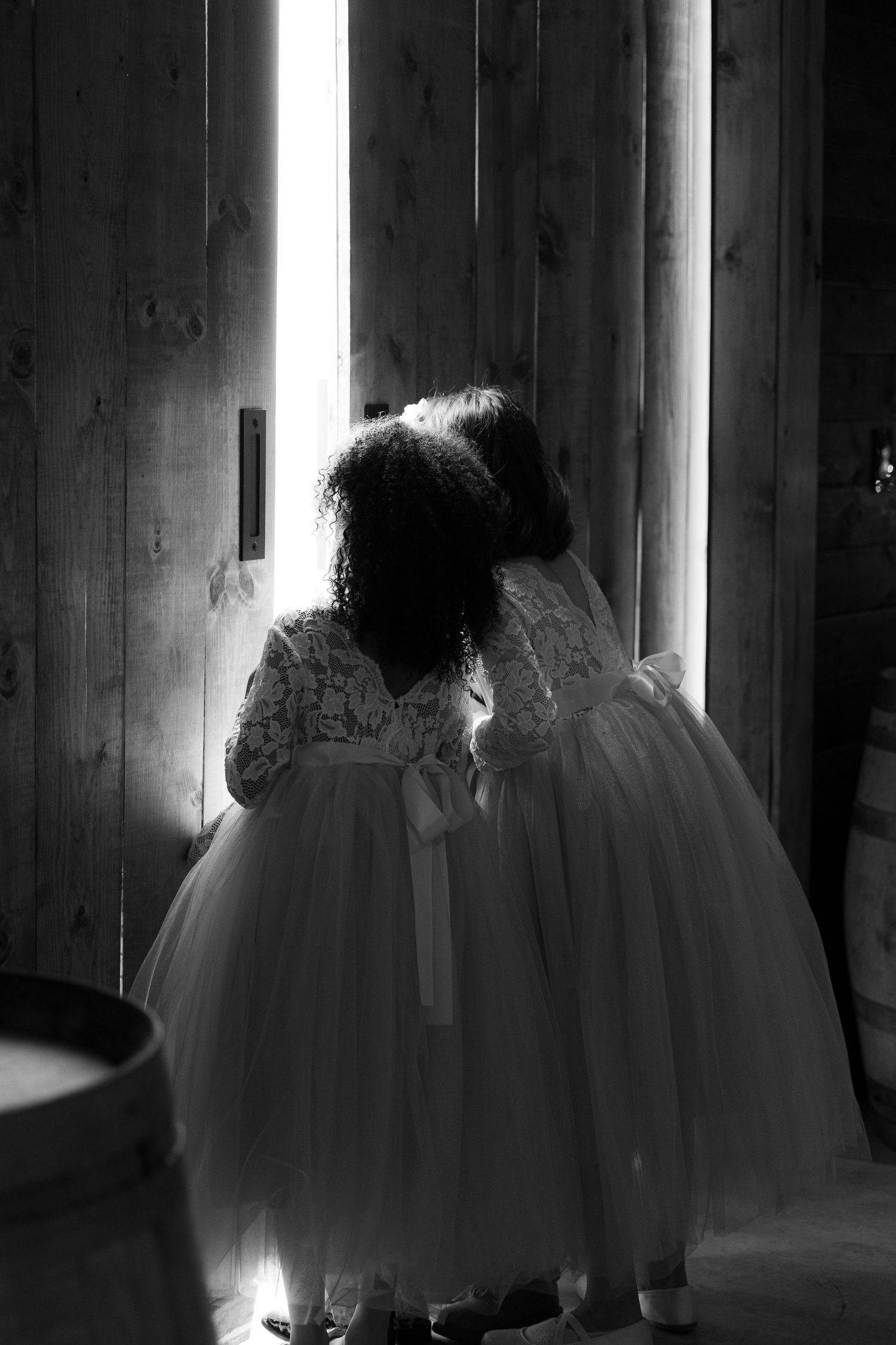 A series of black and white photos showing ethereal silhouettes in flowing white dresses against dark backgrounds.
