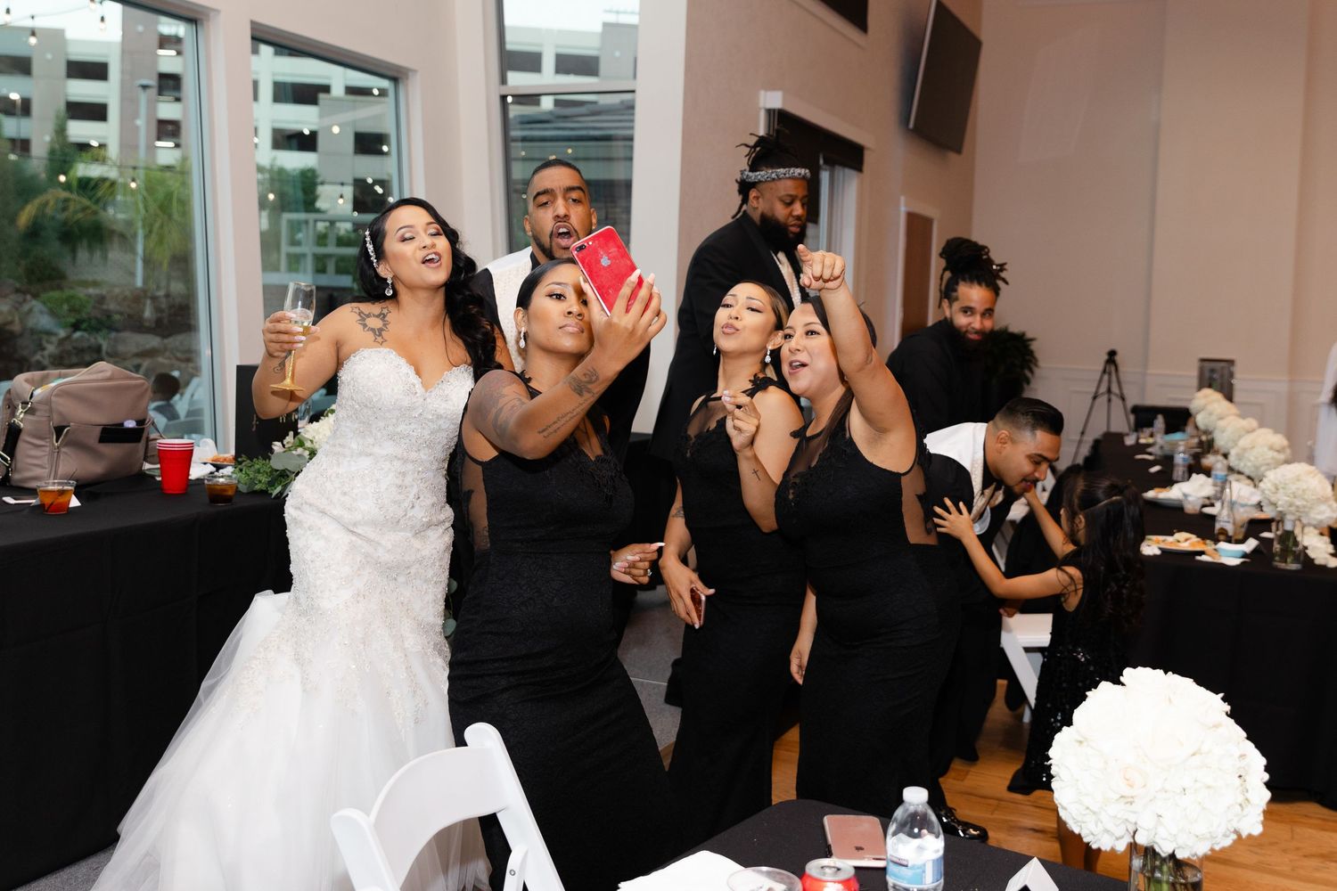 Wedding party dances and celebrates during a lively reception at an indoor venue.