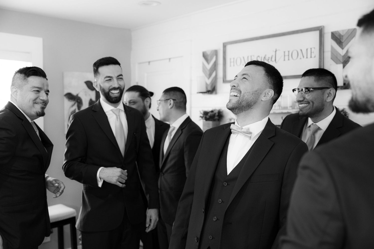 A series of black and white photos showing people in formal attire at what appears to be a business or social gathering.