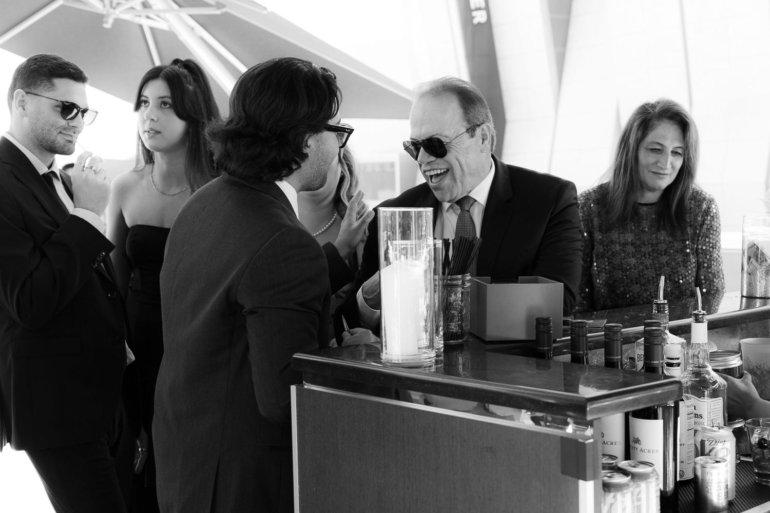 People gathered in a restaurant or bar setting, engaged in conversation and socializing at tables and counters.