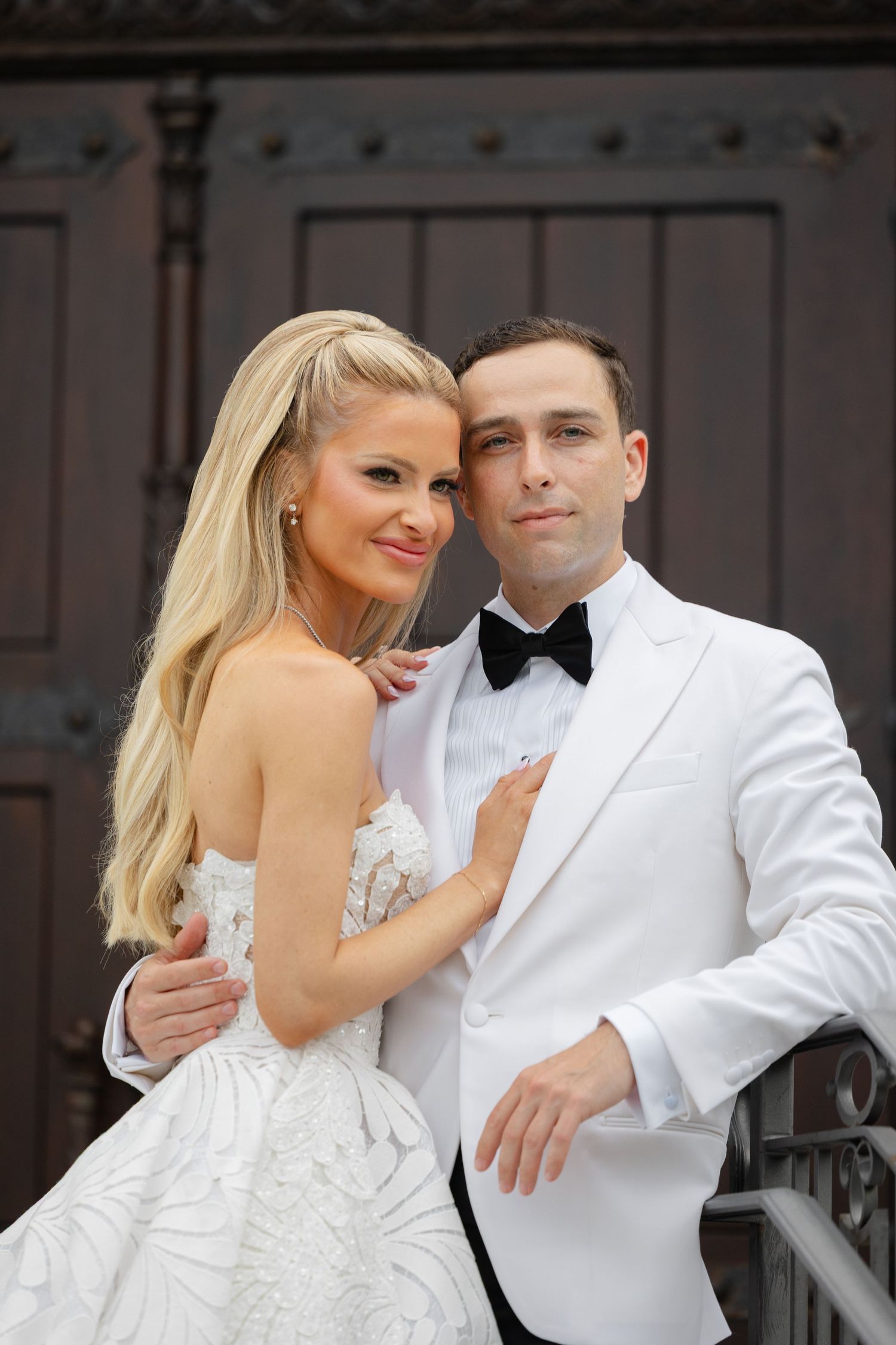 A romantic wedding photo series showing a couple in white formal attire embracing and sharing intimate moments together.