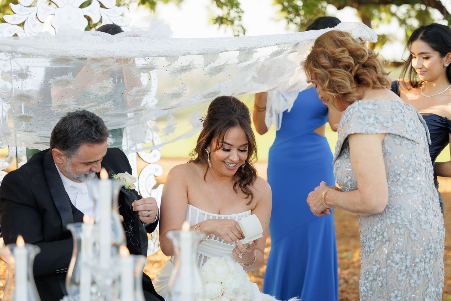 Wedding guests dance and celebrate together on a dance floor during a joyous reception party.
