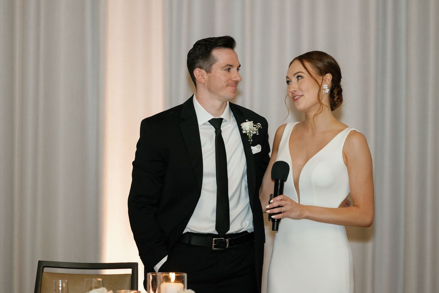 A bride and groom share a joyful moment together during their wedding reception.
