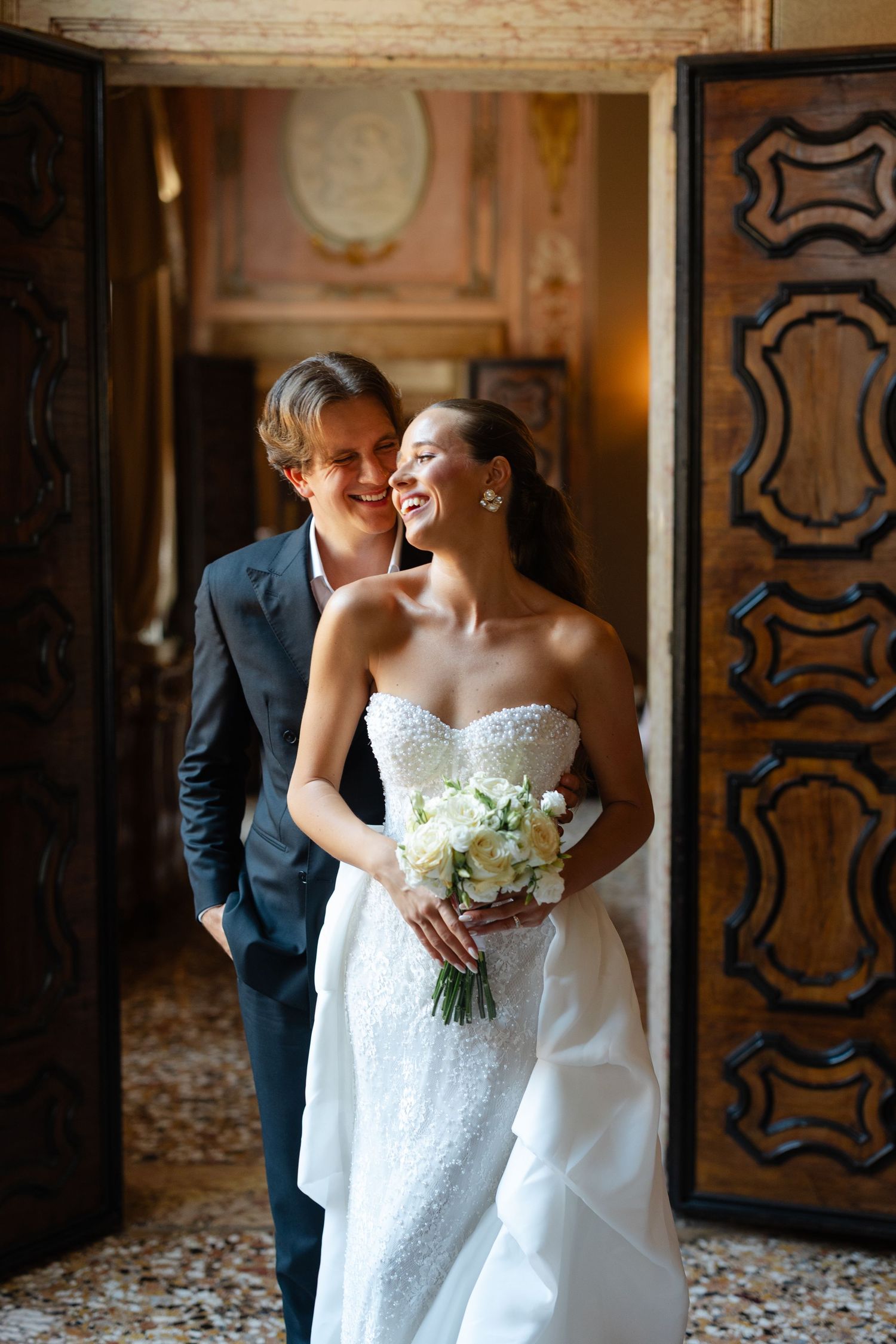 A romantic wedding photo series showing a couple in formal attire sharing intimate moments in an ornate indoor setting.