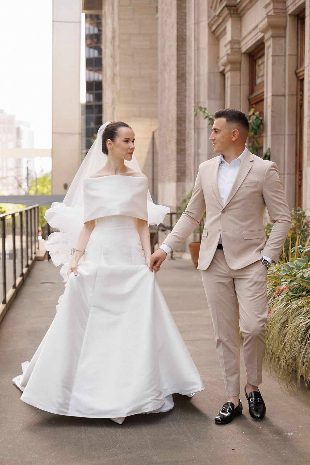 A series of wedding photos showing a couple in beige suit and white dress posing along a columned walkway.