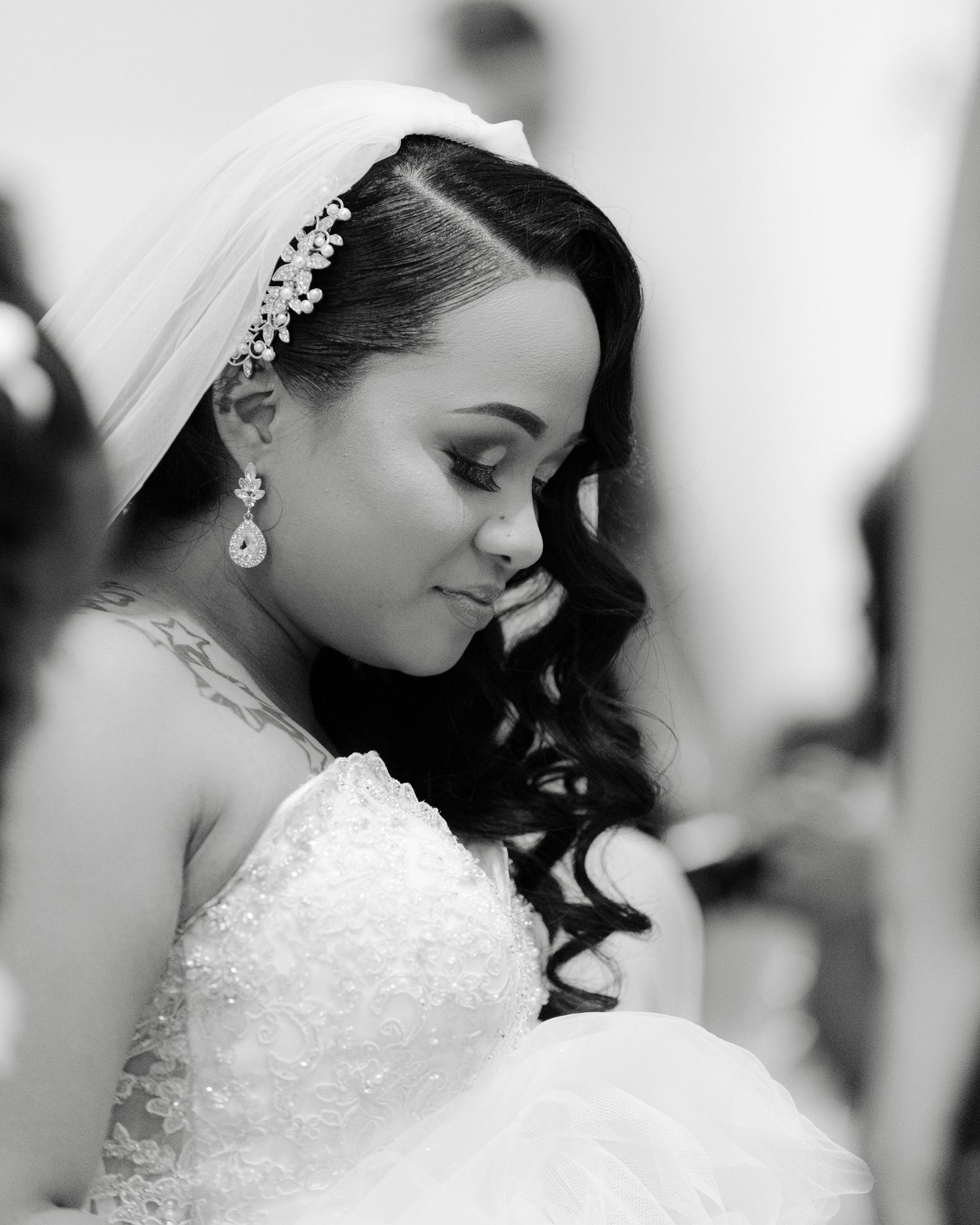 A black and white wedding portrait series showing a bride in an elegant lace dress with delicate hair accessories.