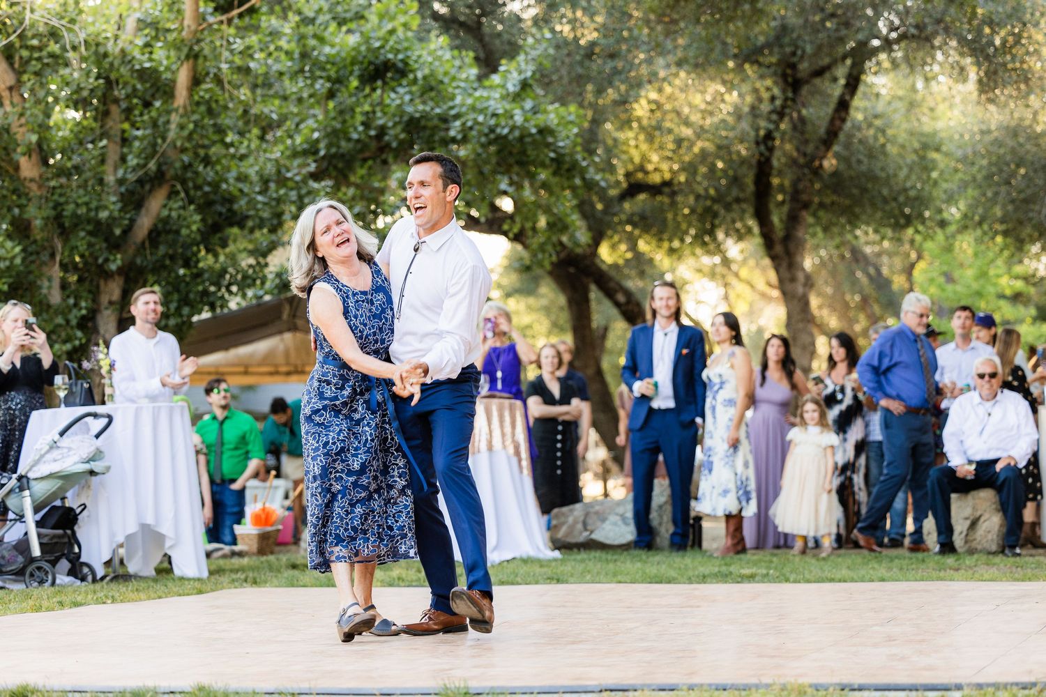 A series of outdoor wedding photos showing guests gathered in a scenic garden setting with trees and natural lighting.