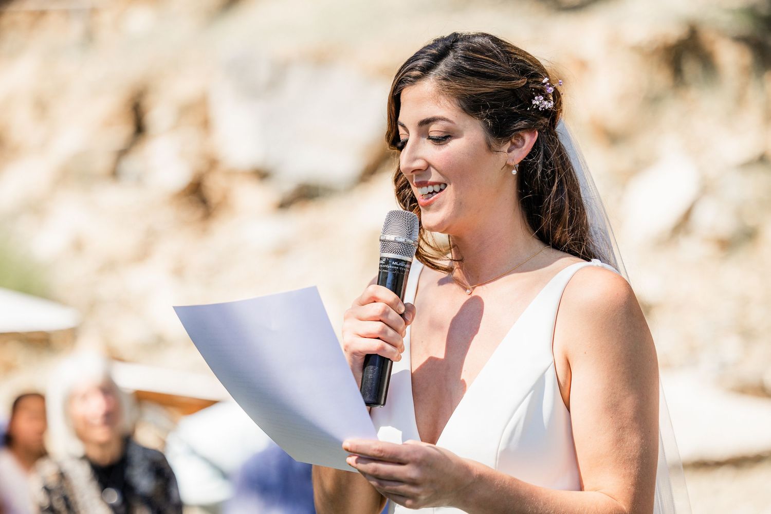 Wedding guest delivers an emotional outdoor speech during a sunny summer celebration.