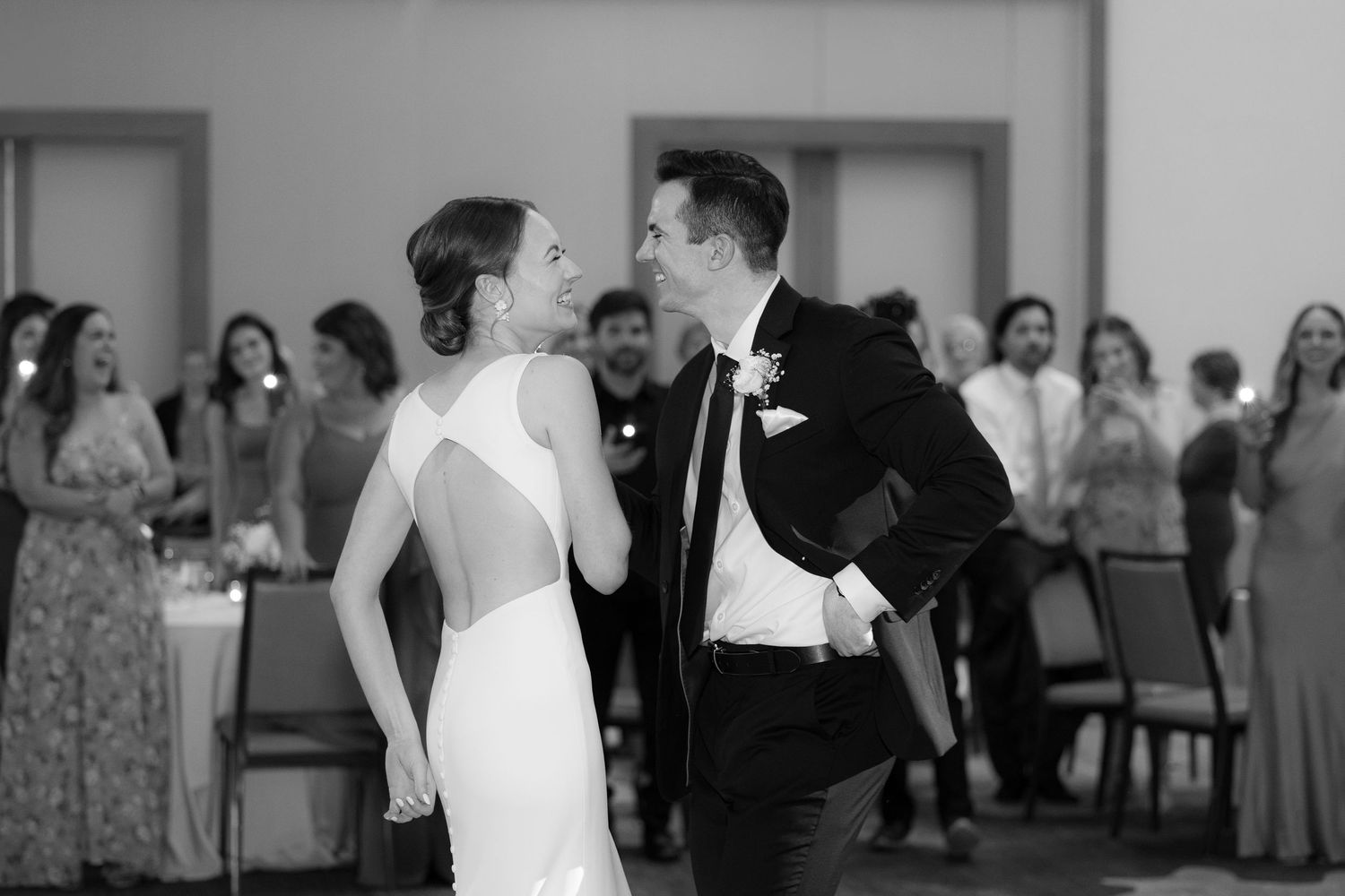 Black and white candid shots of wedding reception dancing and celebration moments.