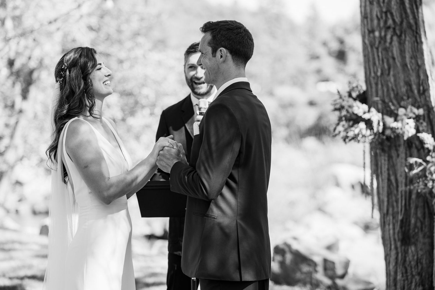 A series of black and white wedding photos showing couples dancing and embracing in an outdoor wooded setting.