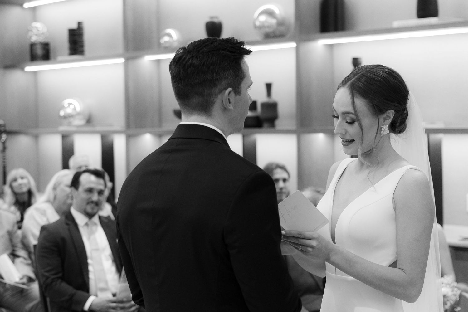 A black and white photo collage of wedding moments showing dancing, embraces and joyful celebration at a reception.