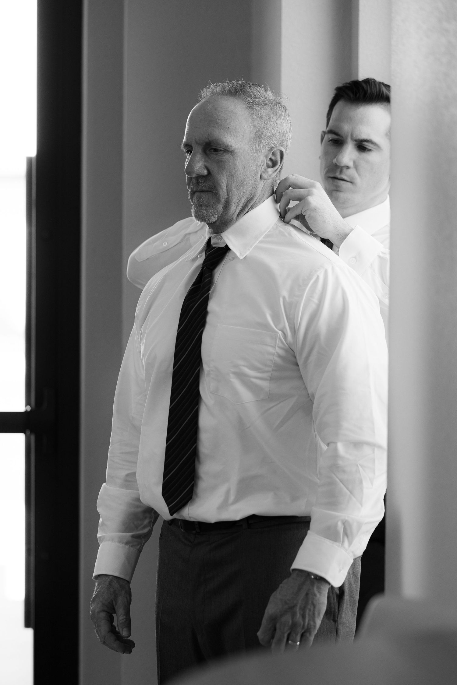 Professional business attire is displayed in black and white with multiple people wearing white shirts and dark ties.