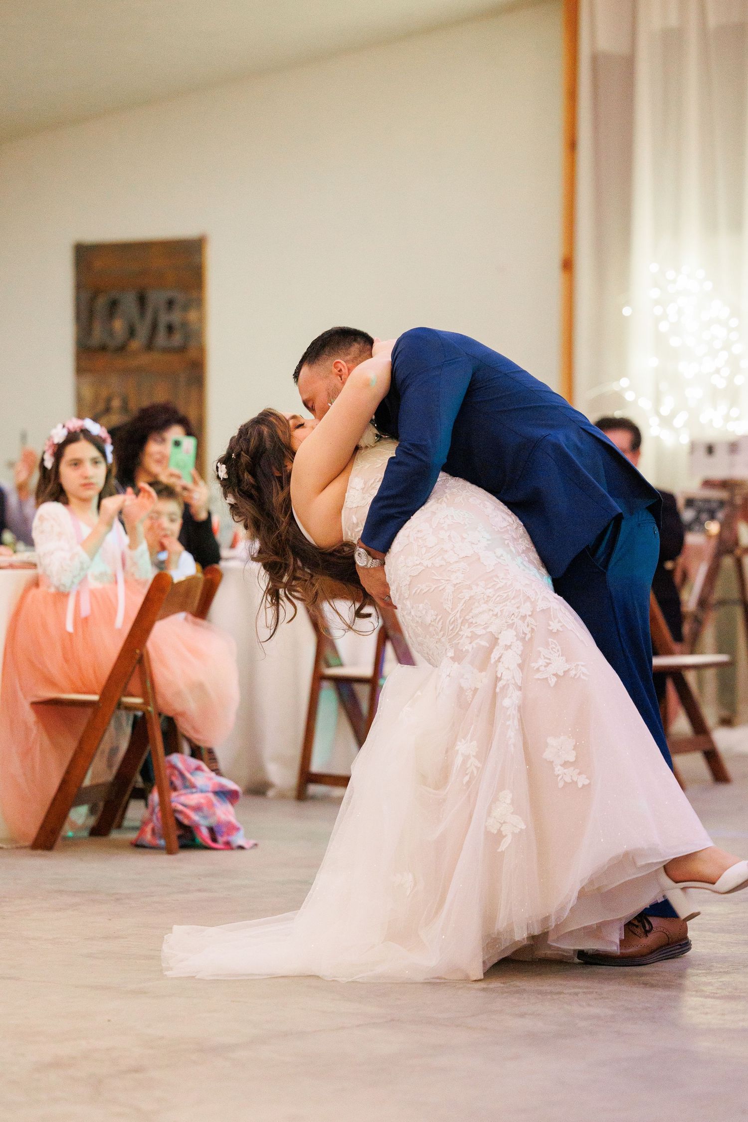 A series of romantic dips between a couple in formal attire showing the progression of a dance move at a wedding reception.
