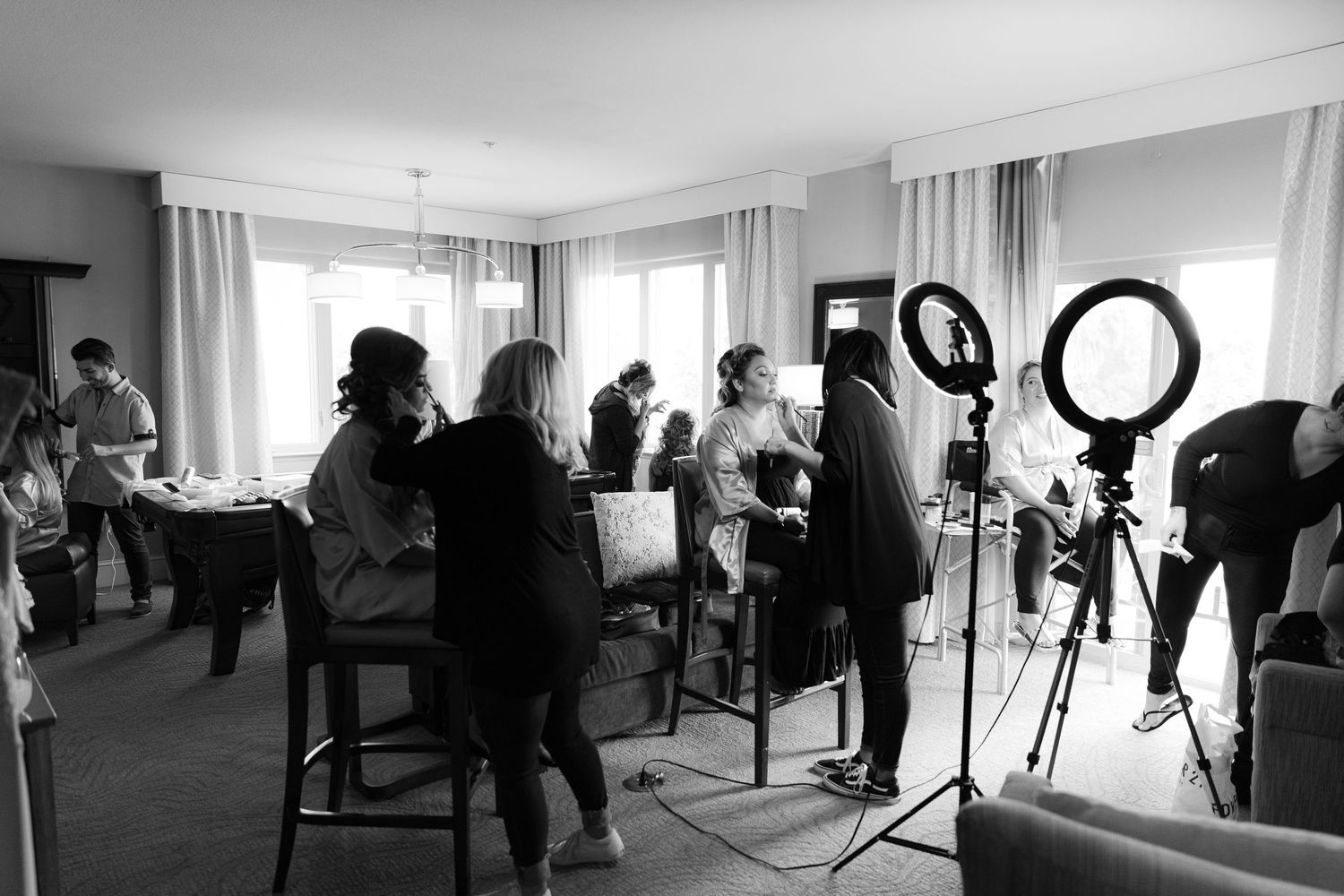 Behind-the-scenes photo of a professional photo shoot setup in a bright studio with lighting equipment and crew.