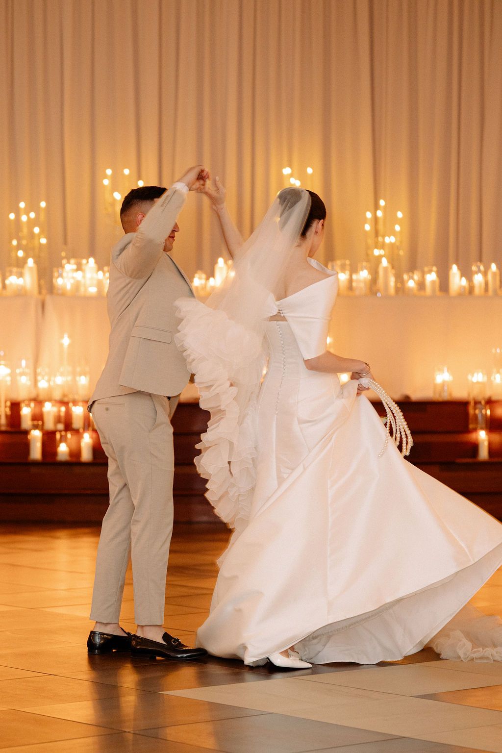 Sequence of wedding dance photos capturing movement of bride's flowing dress in warm-lit ballroom.