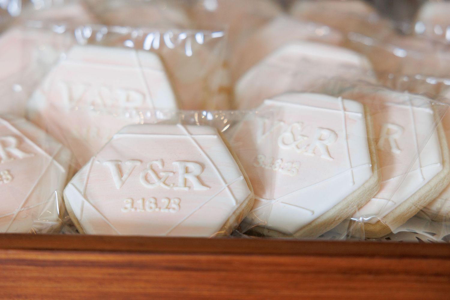 A collection of white soap bars with embossed lettering and designs arranged in rows on a light surface.