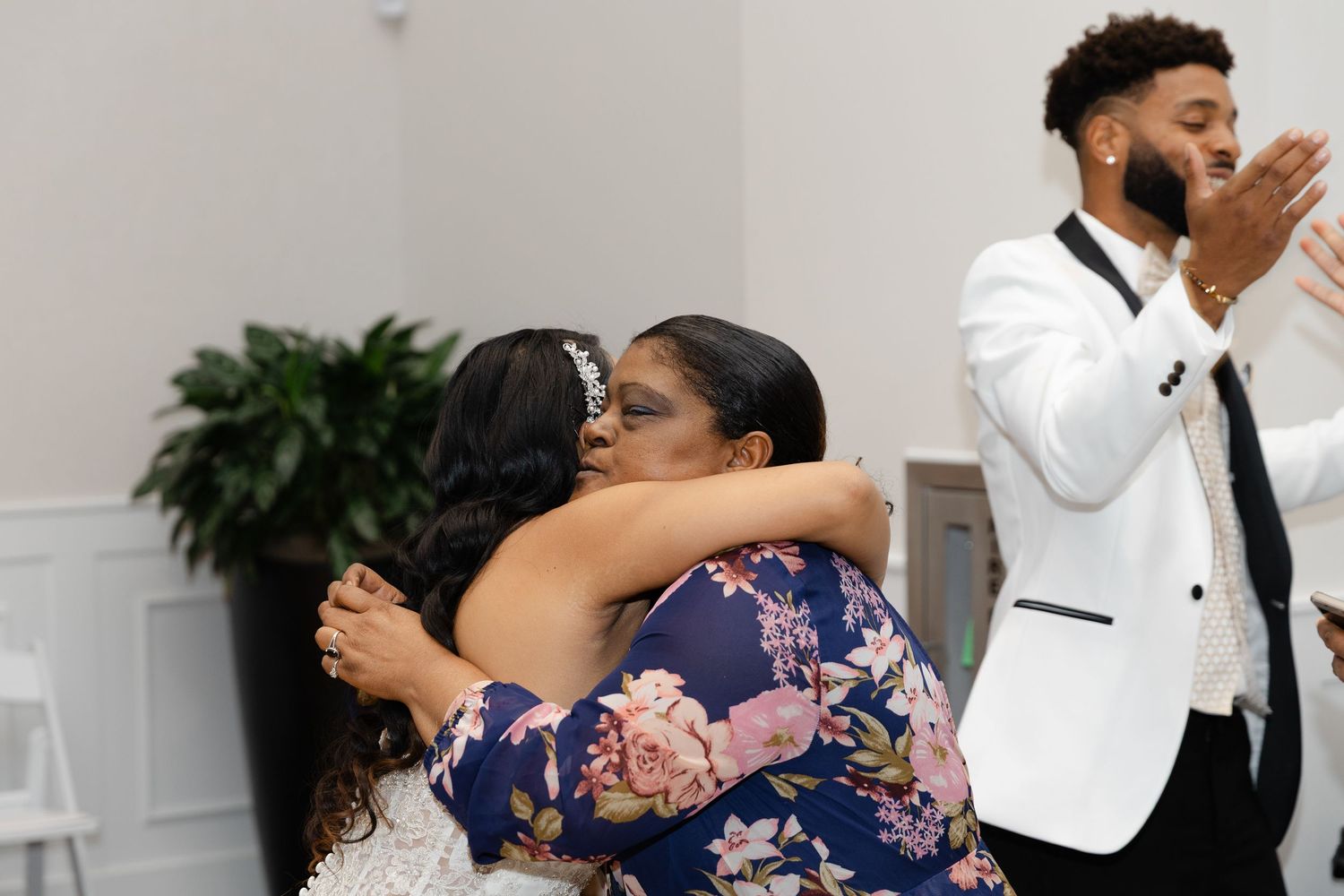 Wedding guests dancing and celebrating on the dance floor at an elegant reception venue.