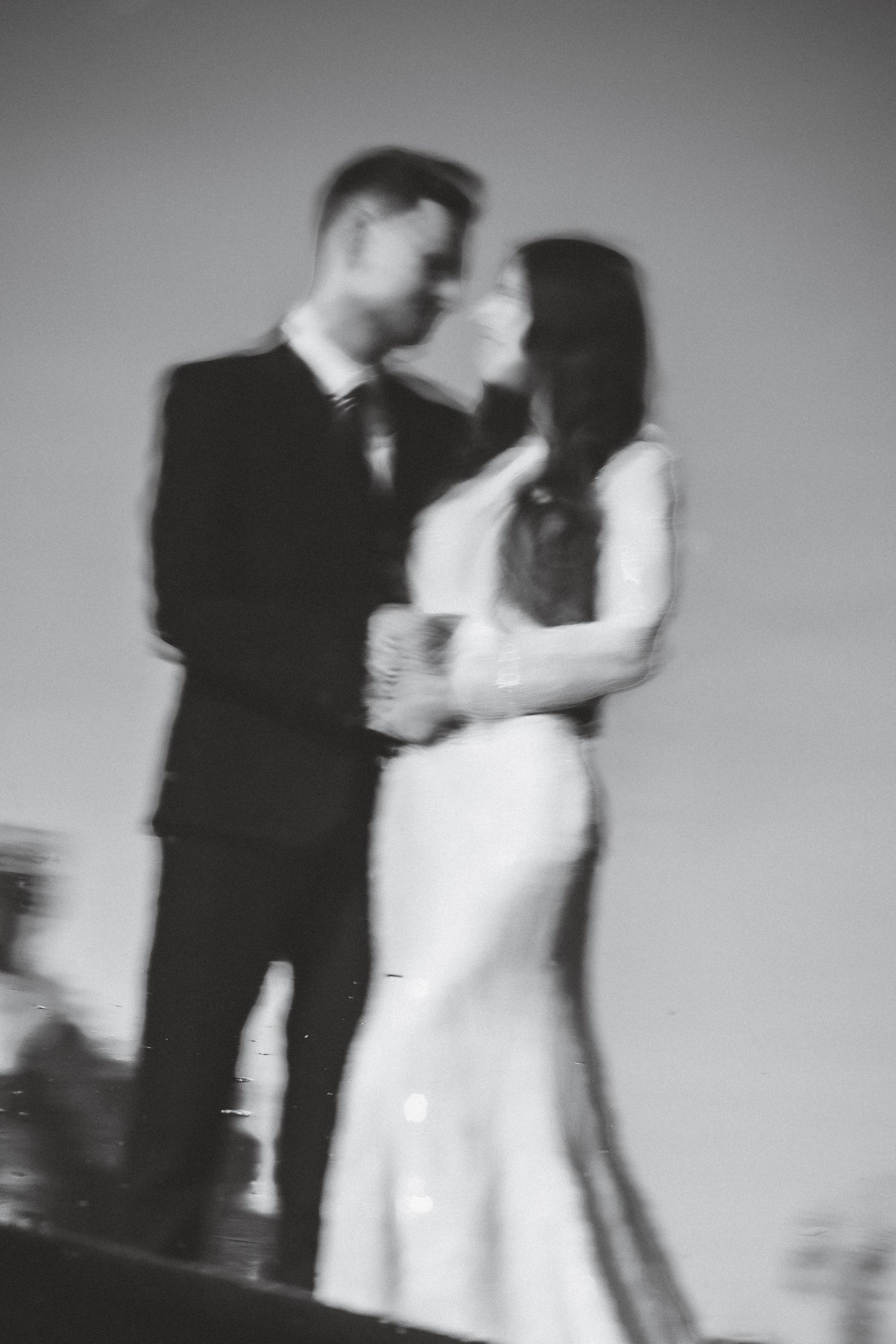 Black and white artistic wedding dance photos showing movement and romance.