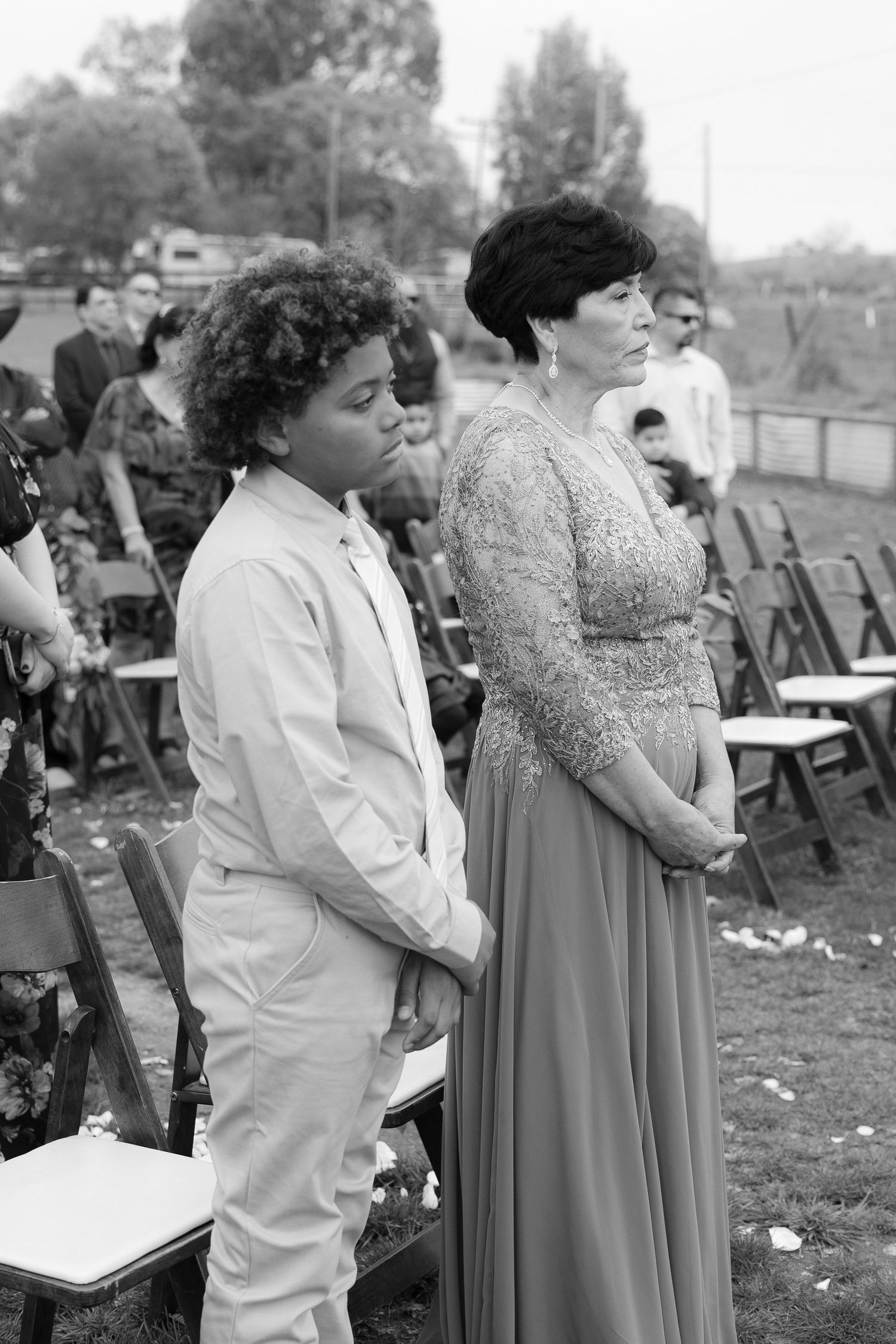 A black and white photo series showing people dancing together at an outdoor event.