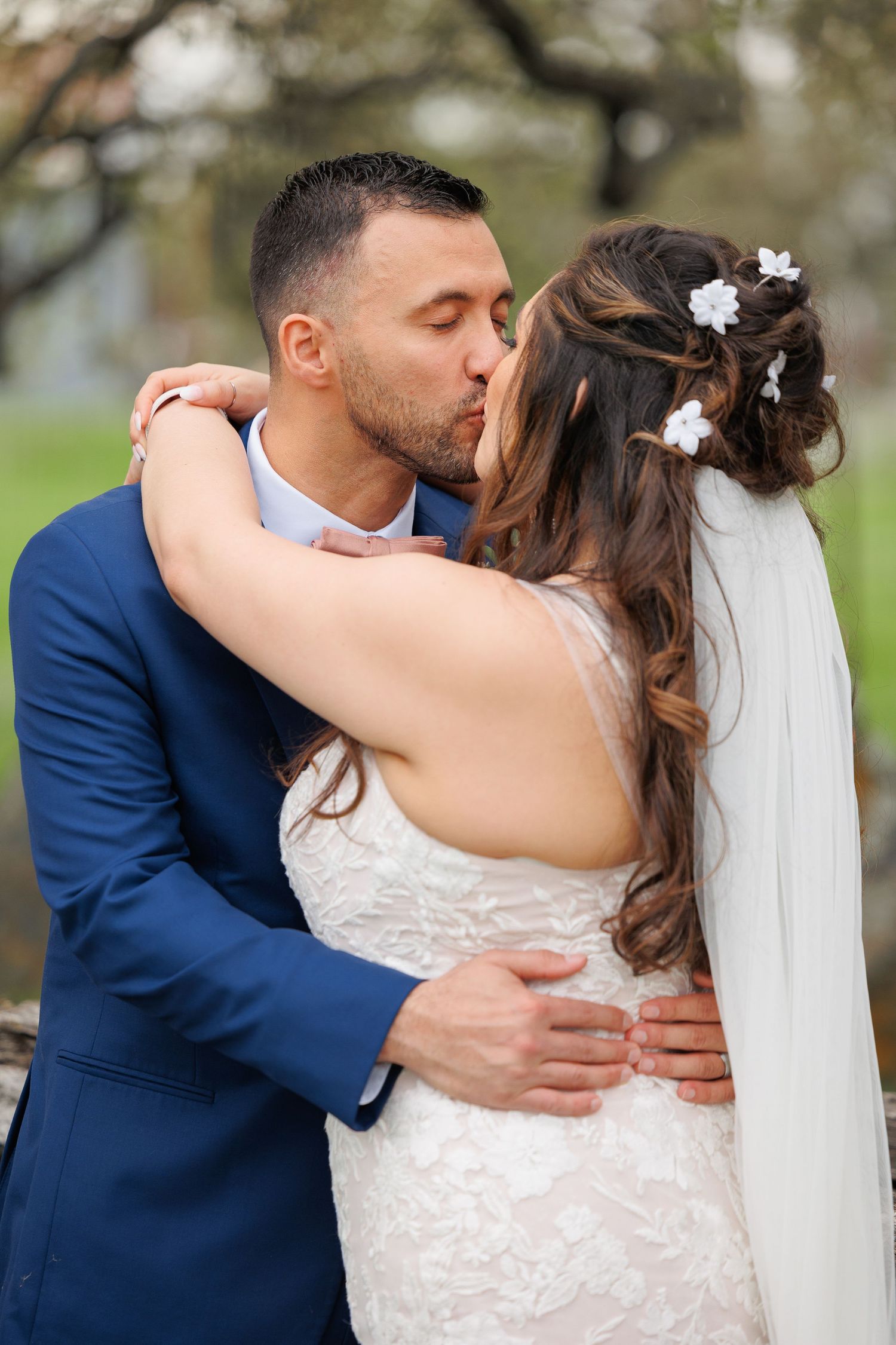 A romantic wedding sequence shows a couple in a navy suit and white lace dress sharing tender kisses outdoors.