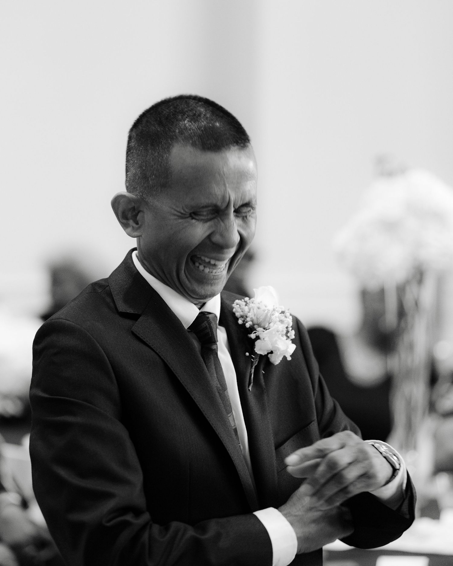 Black and white sequence of candid emotional reactions during a wedding reception showing laughter and joy.