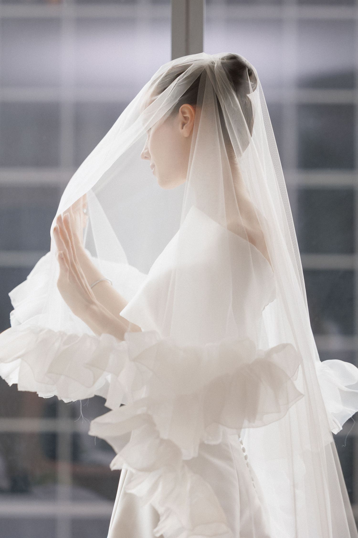 Five cropped images show details of a flowing white wedding dress and veil against a blurred background.