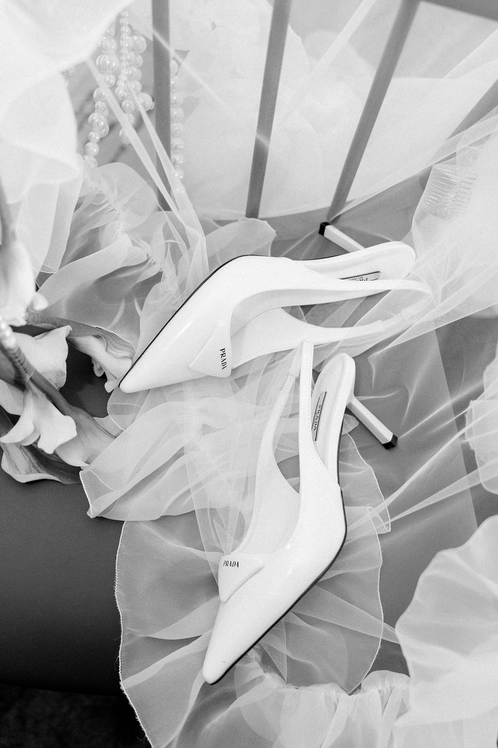 Artistic black and white photos of flowing white tulle fabric creating ethereal shapes and textures.