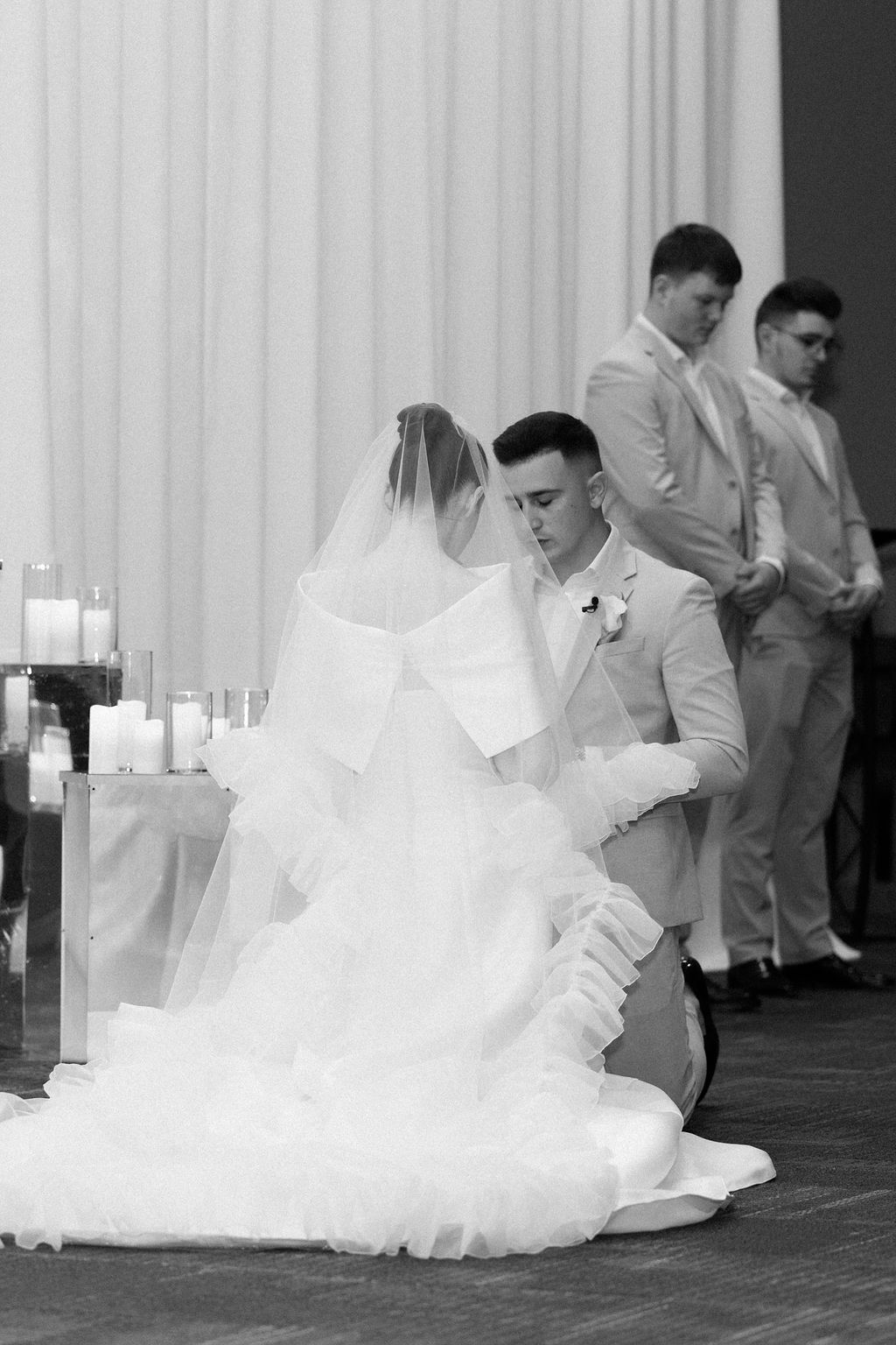 Black and white photo series showing elegant wedding dance dips in a ballroom setting.