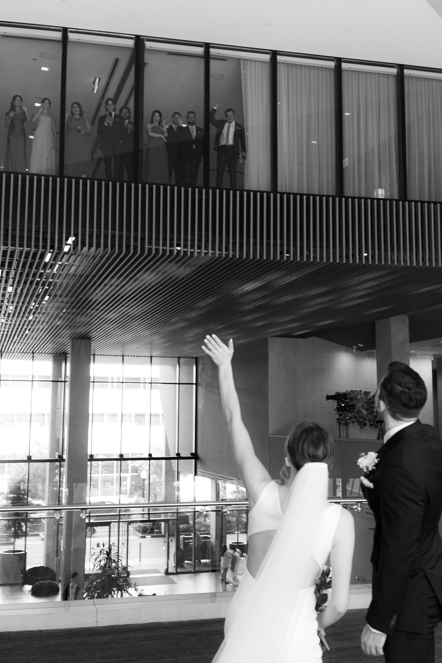 A sequence of four black and white photos showing a couple dancing in an elegant venue with large windows.