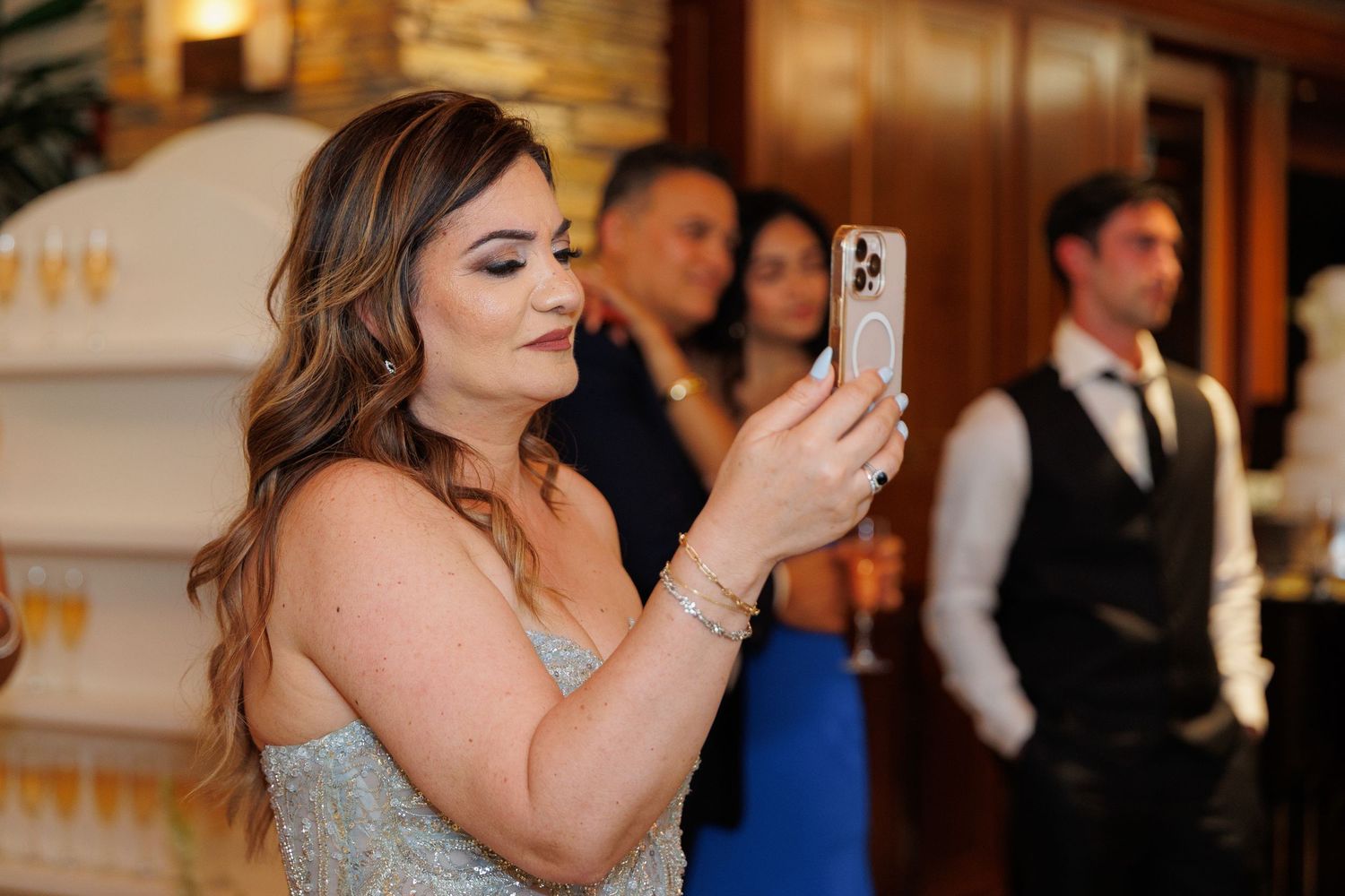 A series of wedding reception photos showing guests dancing and celebrating at an elegant indoor venue.