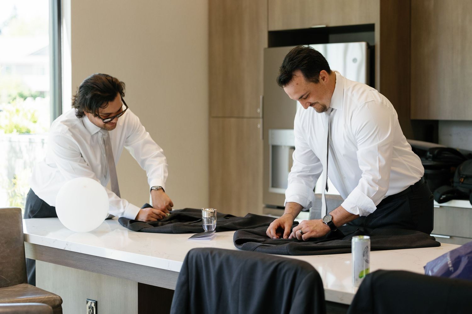 Medical professionals in white coats work at desks in a bright office setting during the day.
