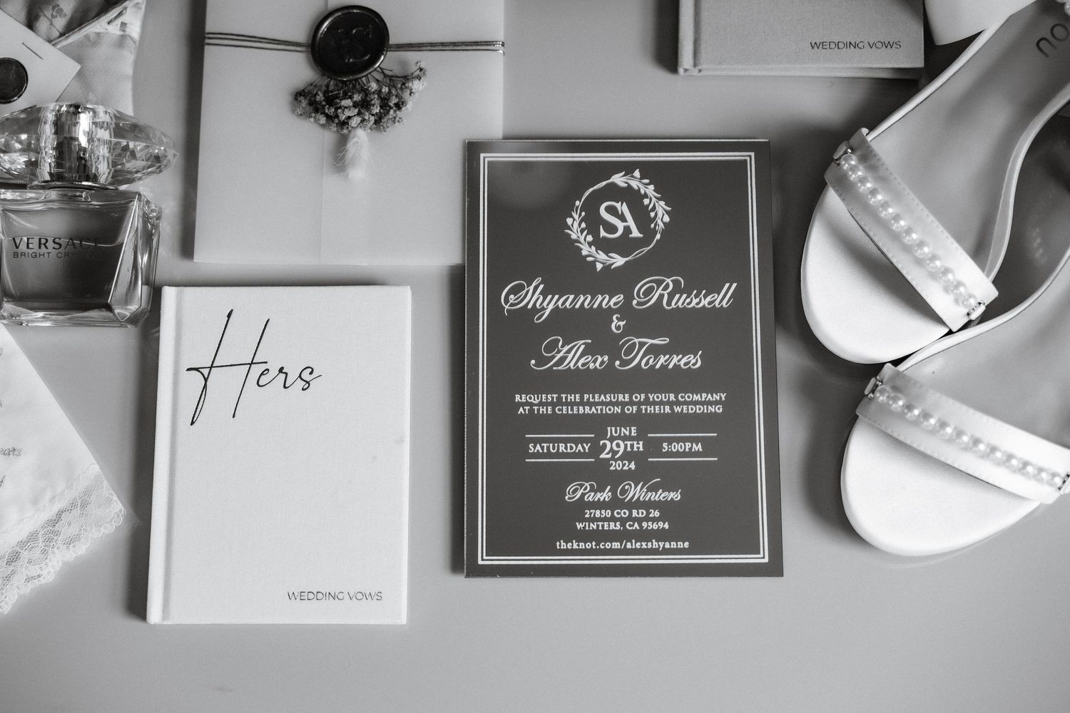 A collection of elegant black and white wedding invitations and stationery arranged in a flat lay composition.