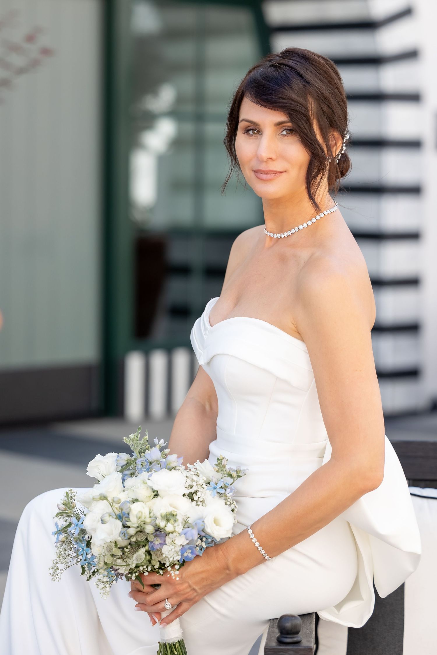 Elegant bridal portrait series featuring white strapless gown with bow detail and blue-white bouquet.