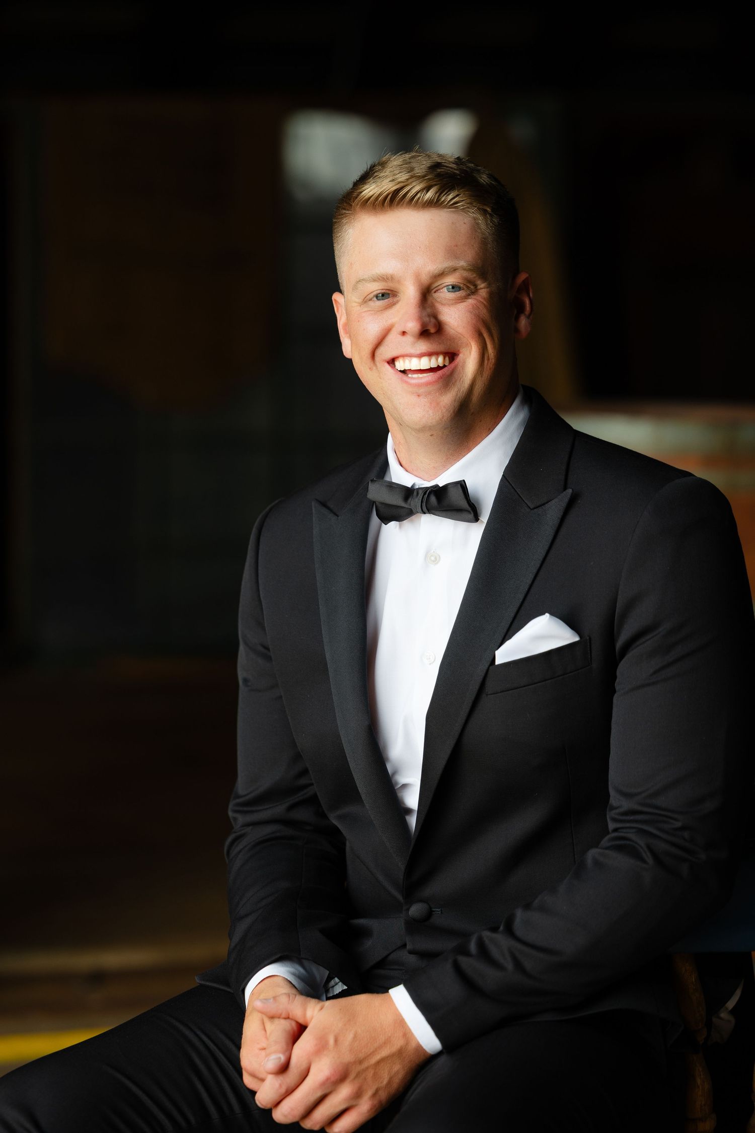 Professional portrait series showing a person in a classic black tuxedo and white dress shirt against a dark background.