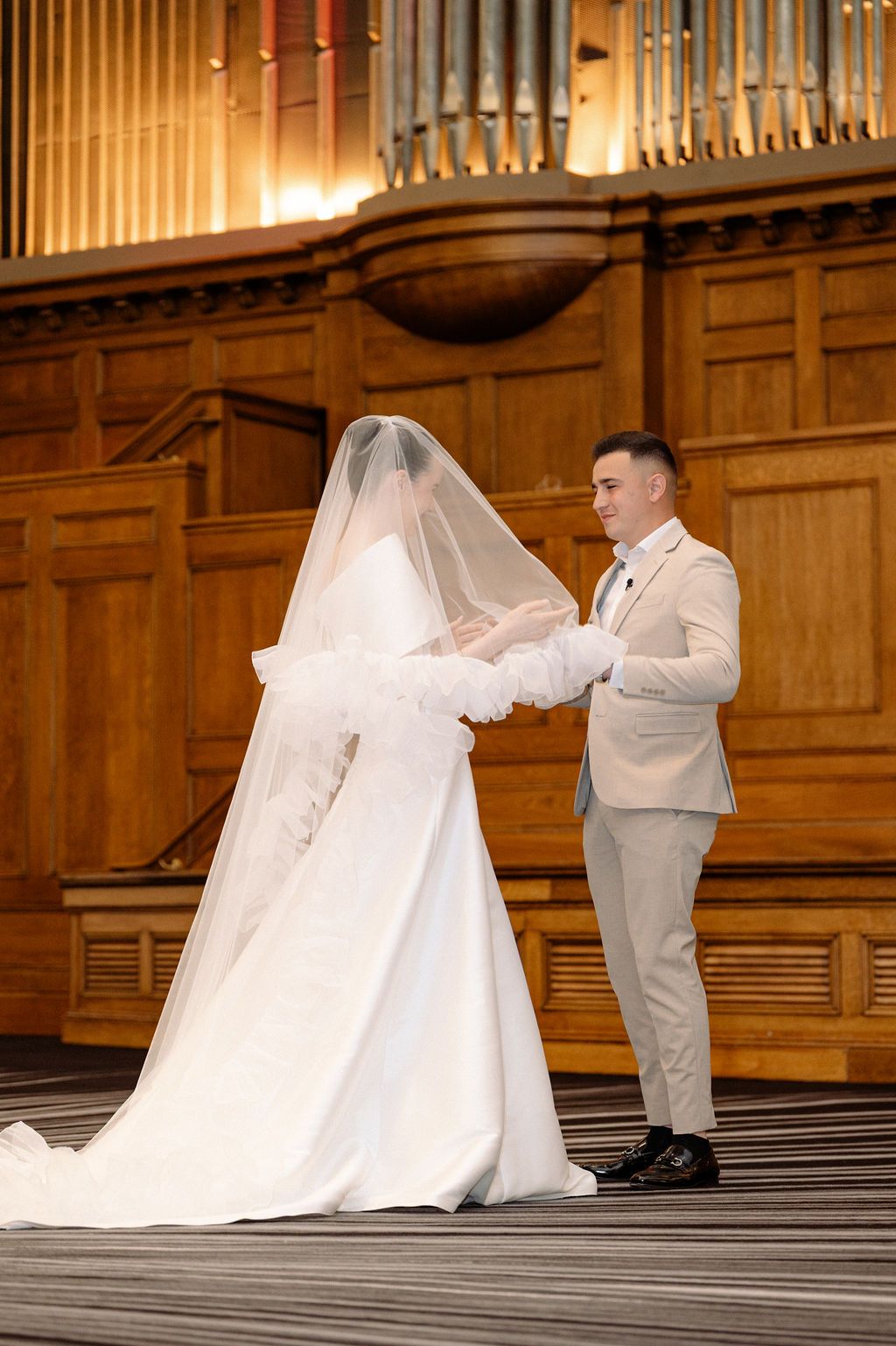 A sequence of romantic wedding photos showing a couple in white and beige dancing together in an elegant venue.