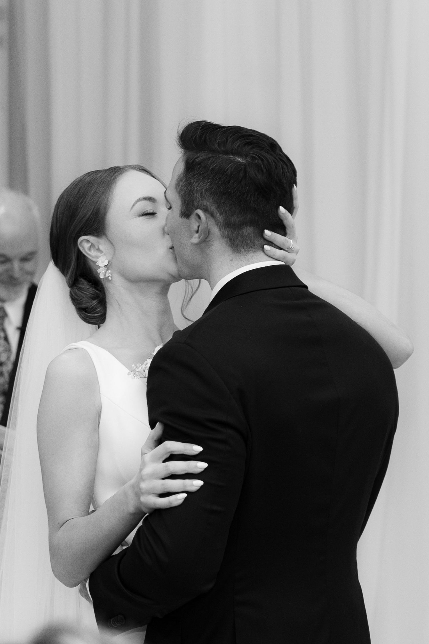 A romantic sequence of wedding photos showing a couple sharing their first kiss as newlyweds.