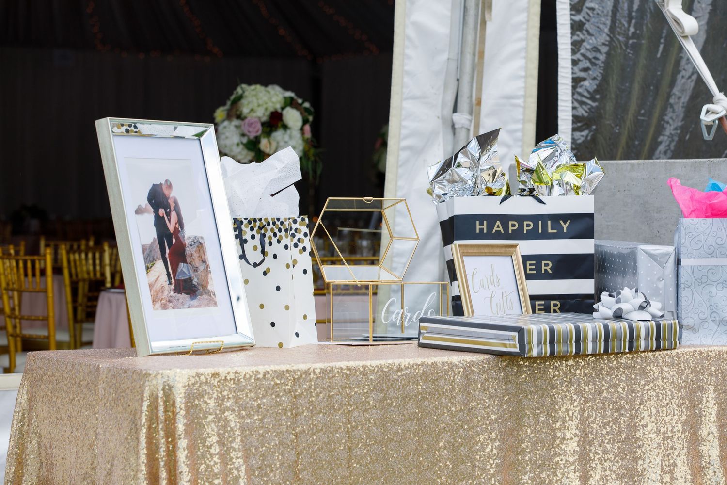 Wedding photo display with multiple framed pictures and decorative elements arranged on a white surface.