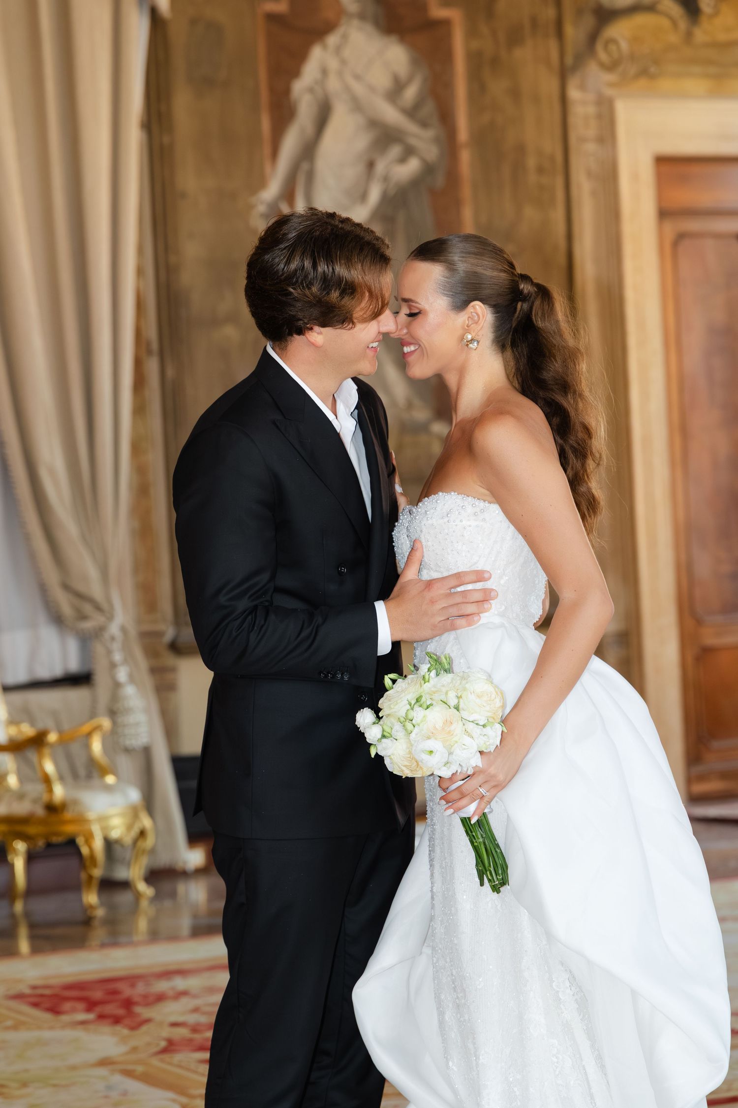 A romantic wedding sequence showing a couple sharing their first kiss in a grand ballroom setting.