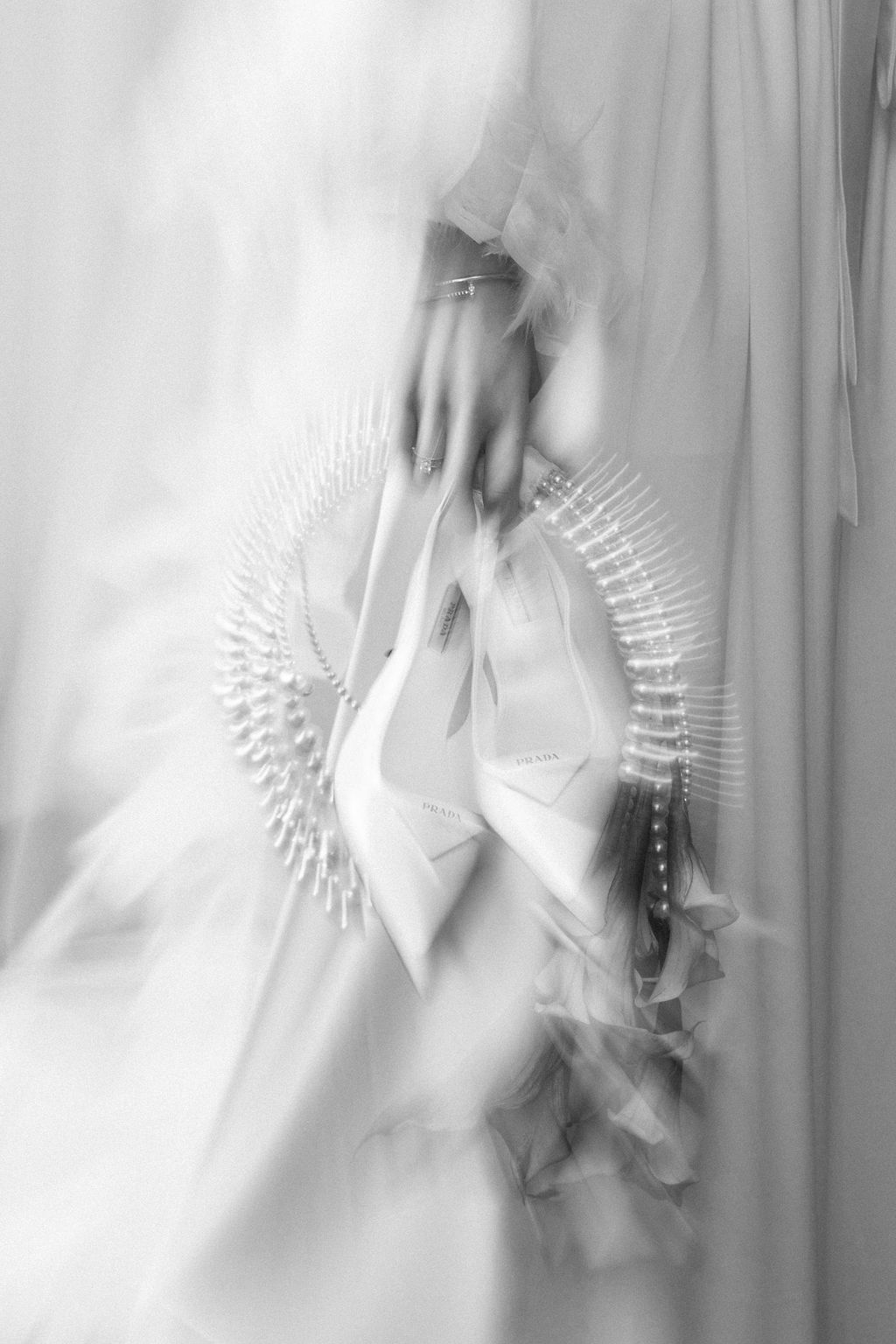 A series of abstract black and white photographs showing motion blur of hands with fan-like shapes against a light background.